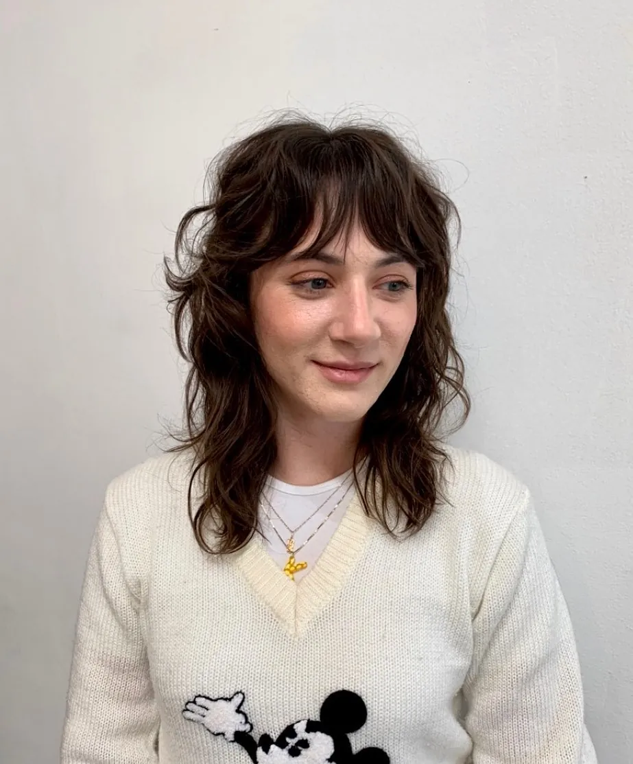 Wavy medium shag with airy bangs and textured layers