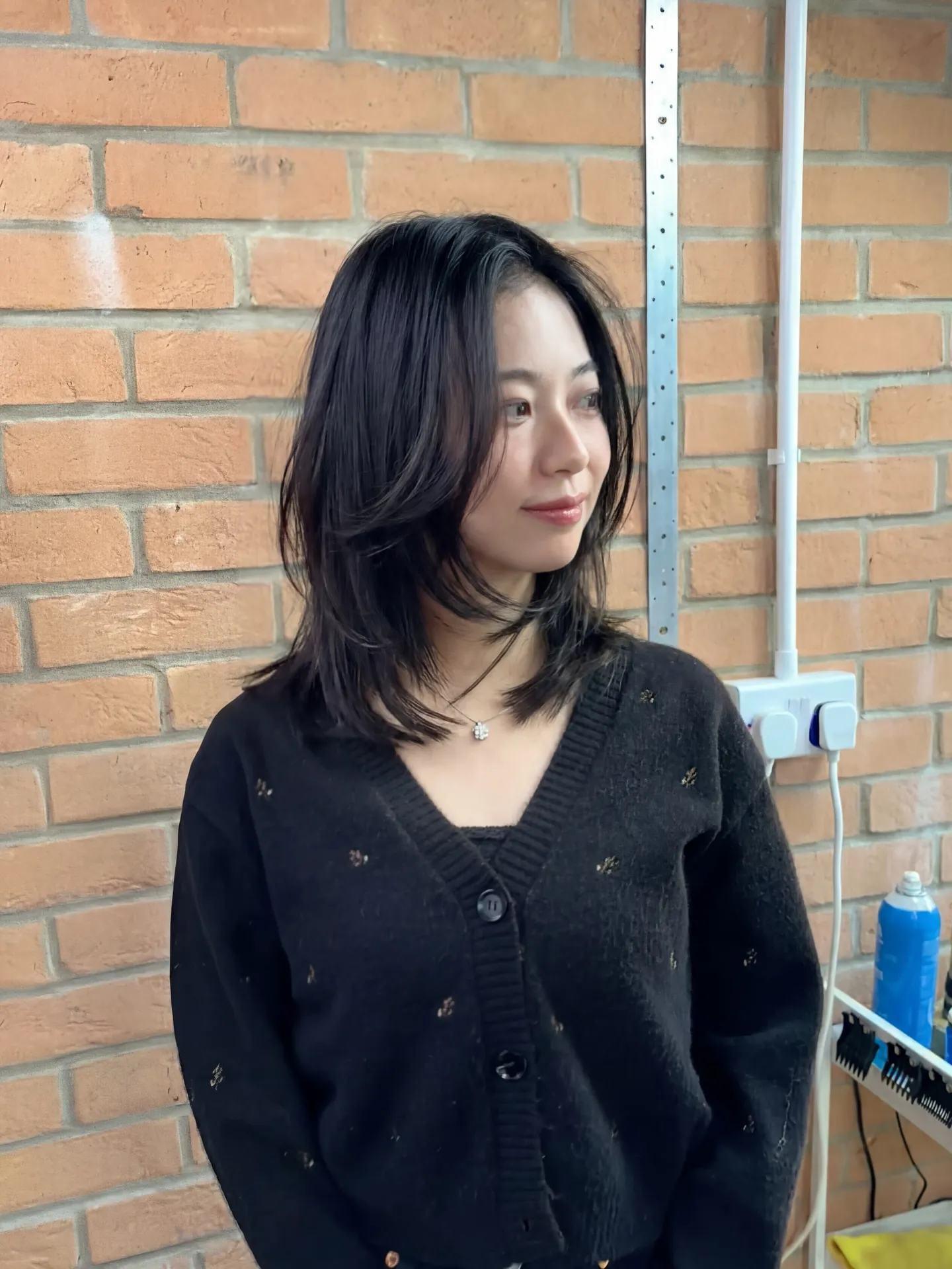 Sleek dark medium hair with long face-framing layers
