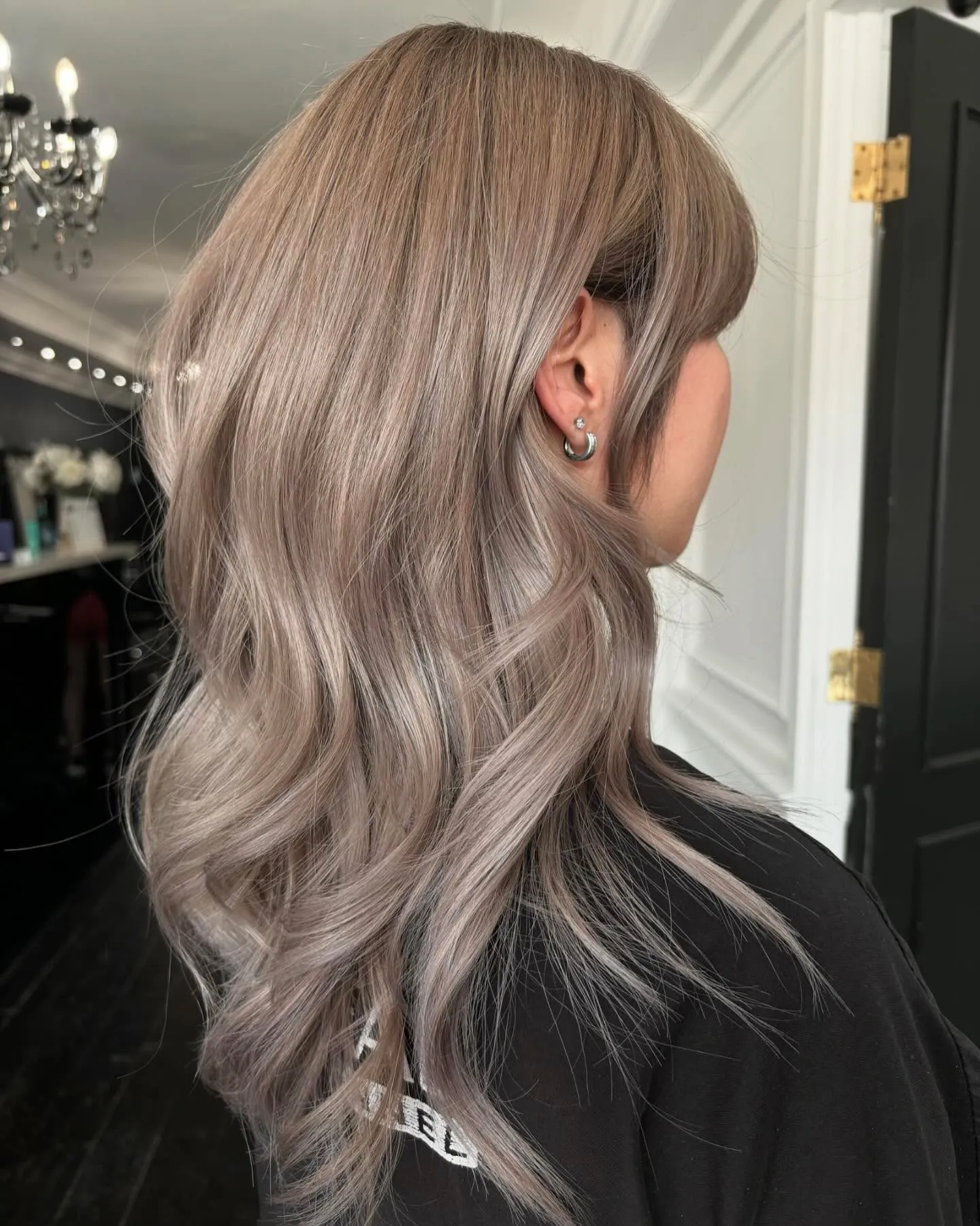 Shoulder-length neutral blonde hair with soft waves