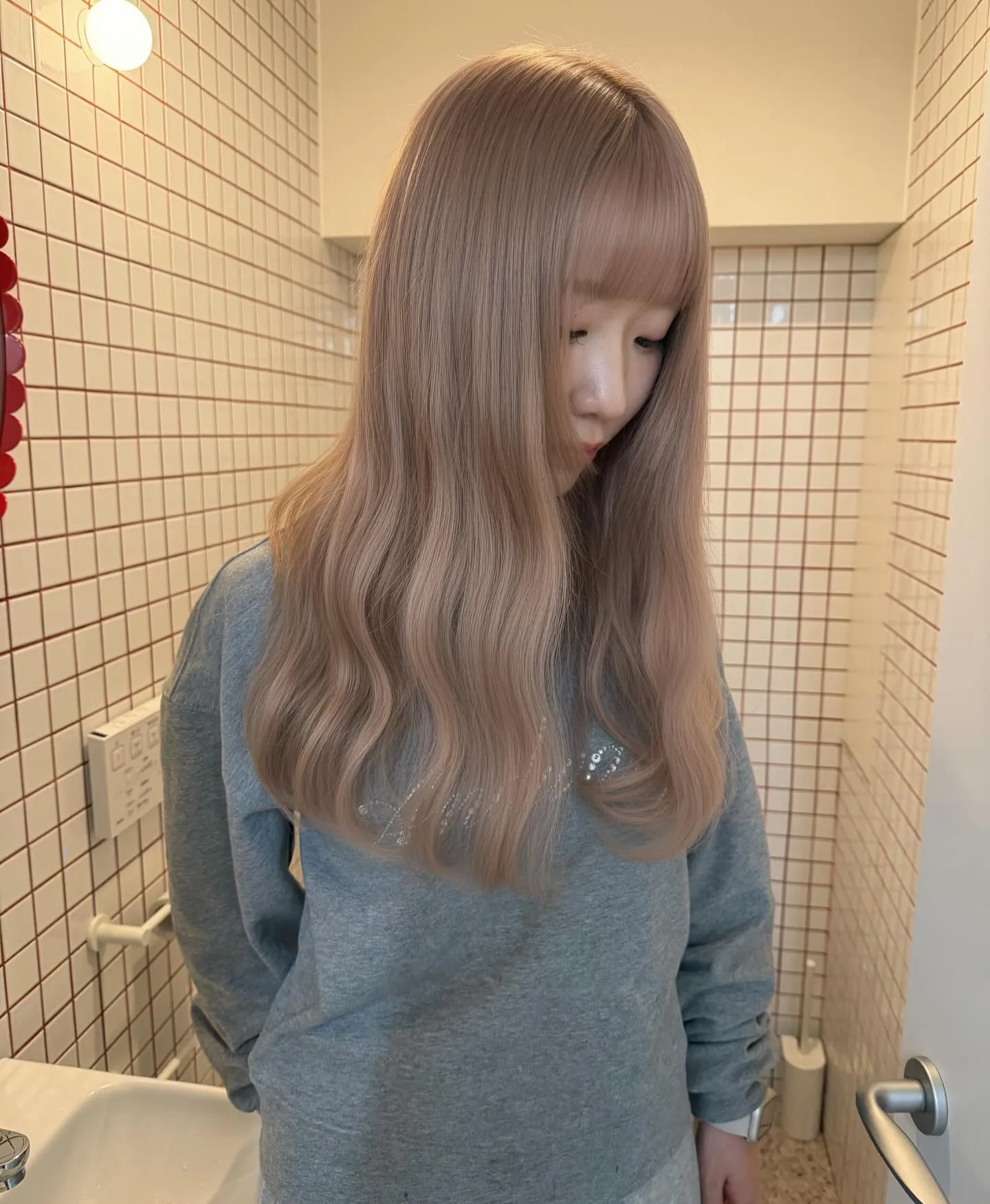 Long softly waved blonde hair with a full straight fringe