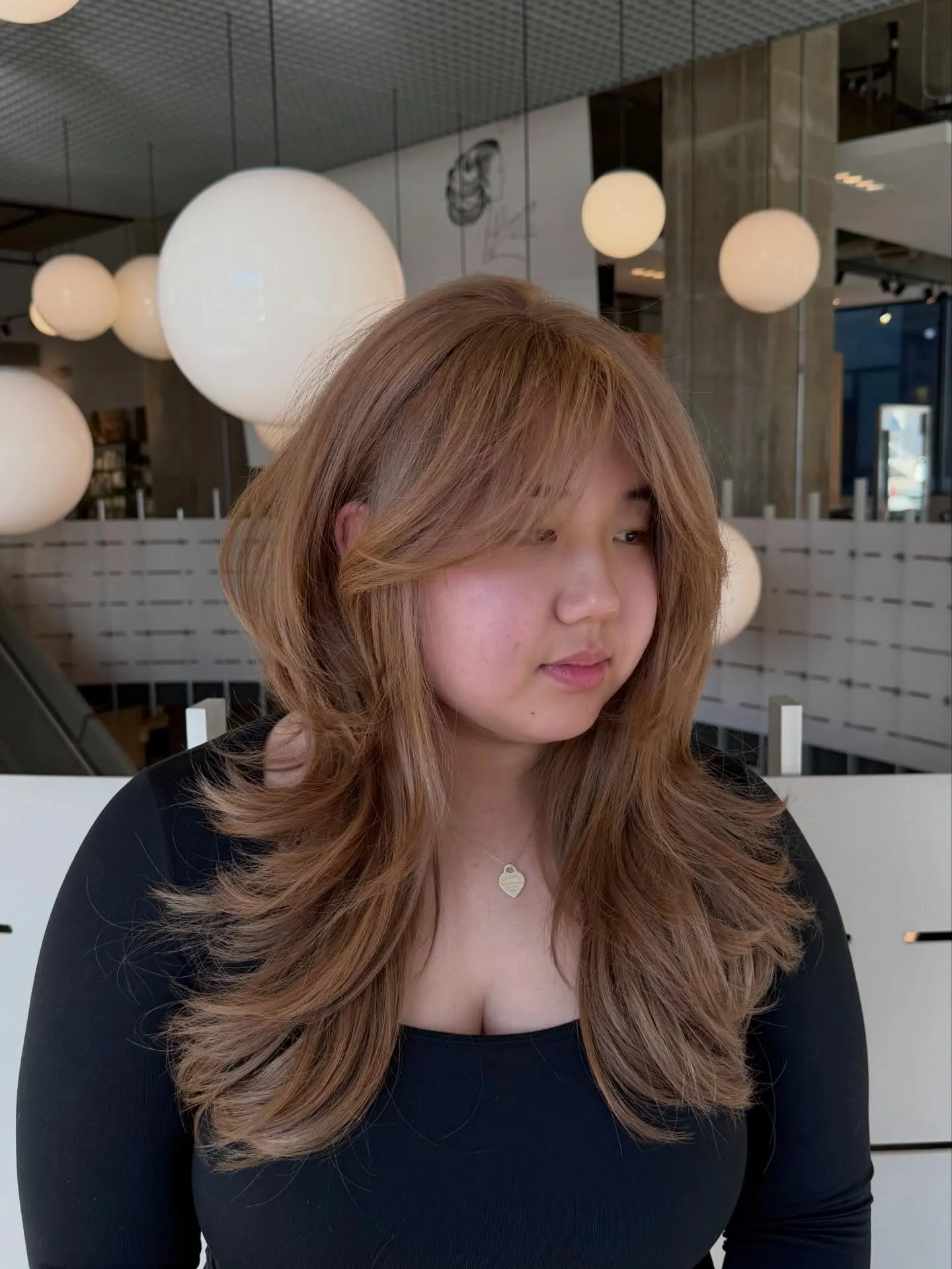 Long feathered blonde layers with soft face framing
