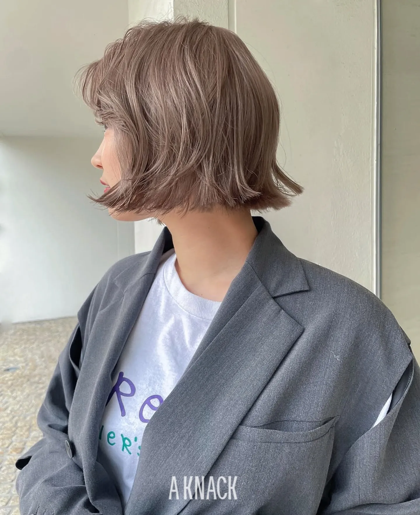 Short layered blonde bob with softly flipped ends