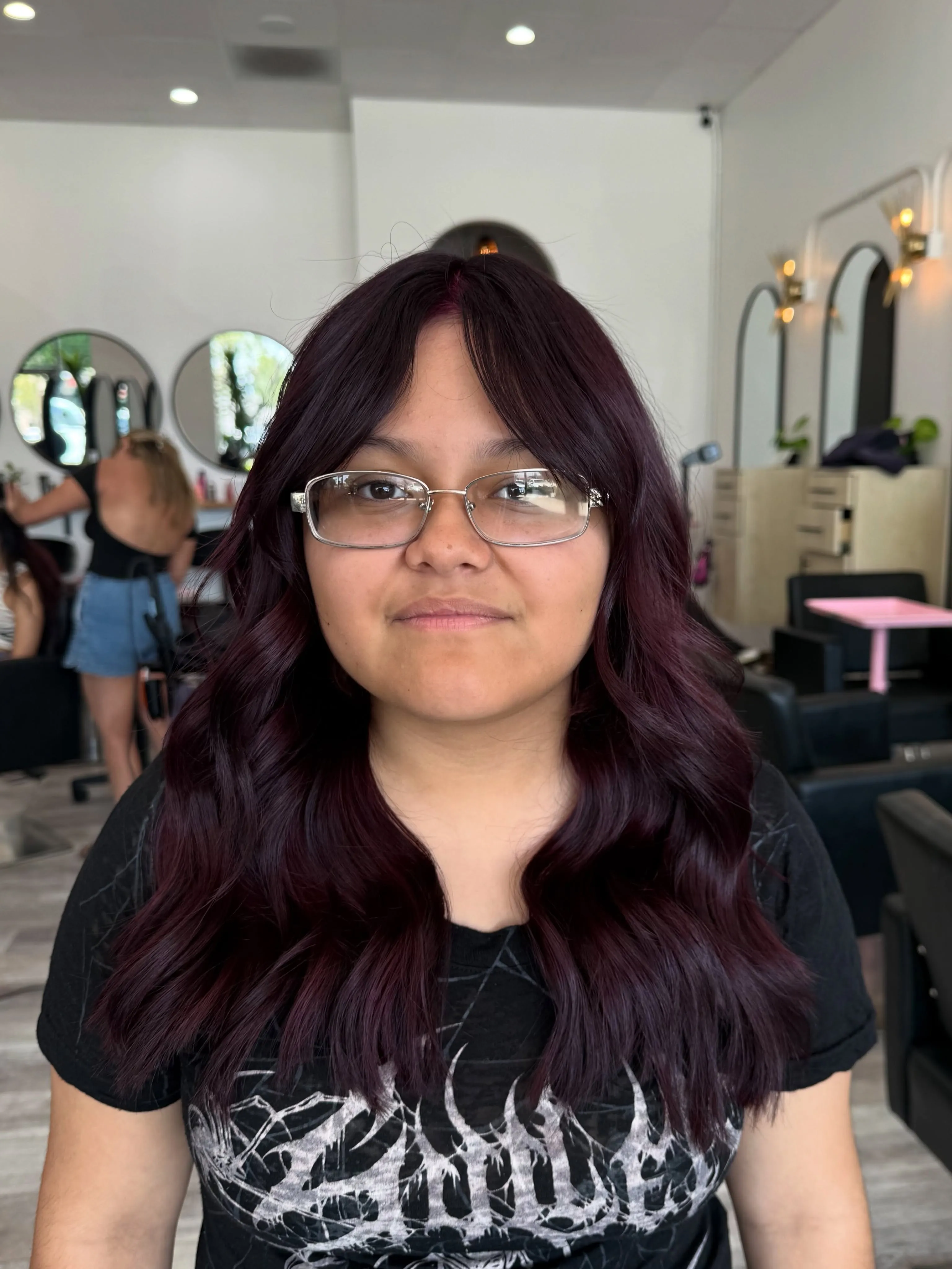 plum hair with center-part waves
