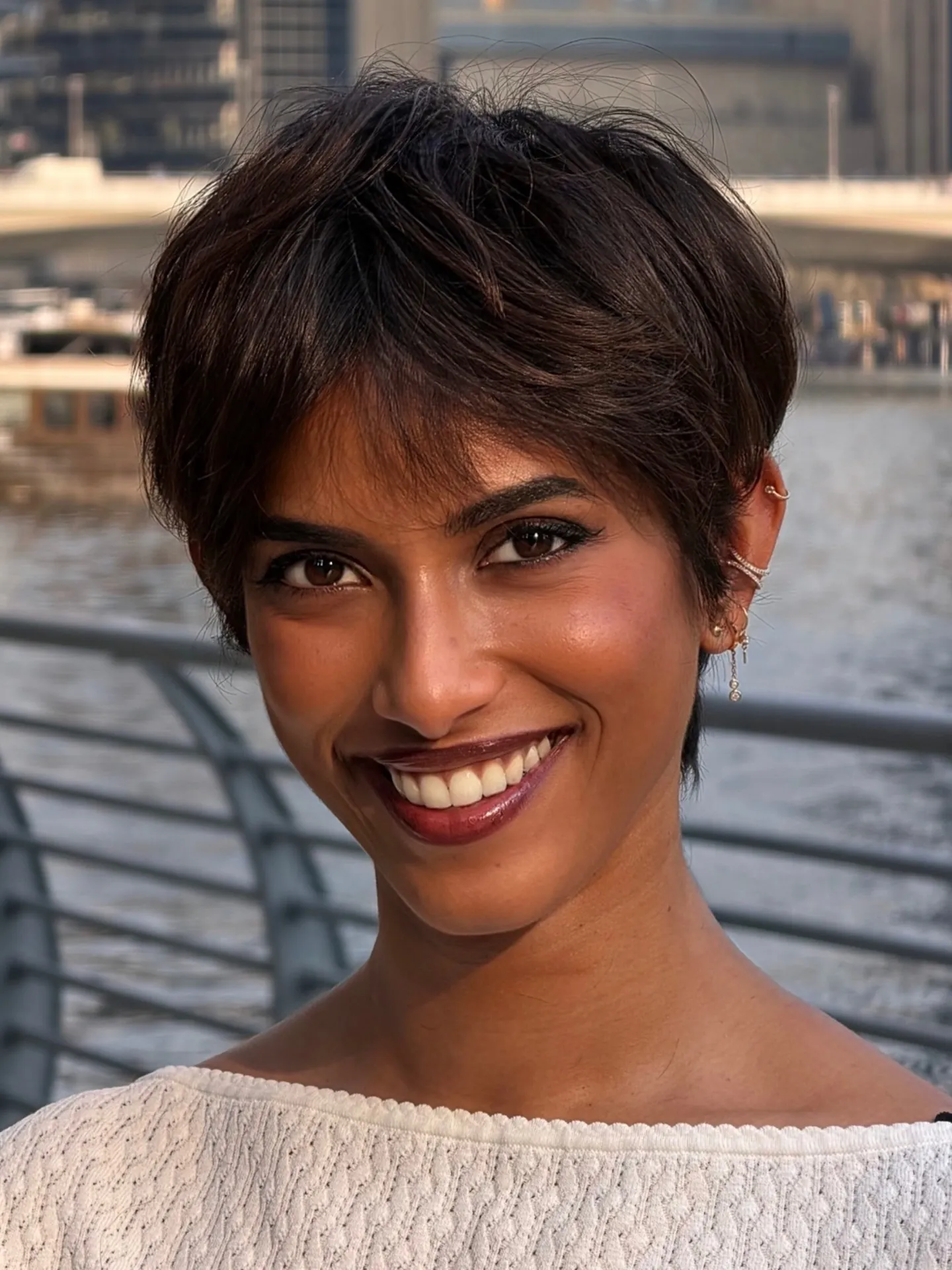 Dark pixie with a long side-swept fringe and softly tapered nape