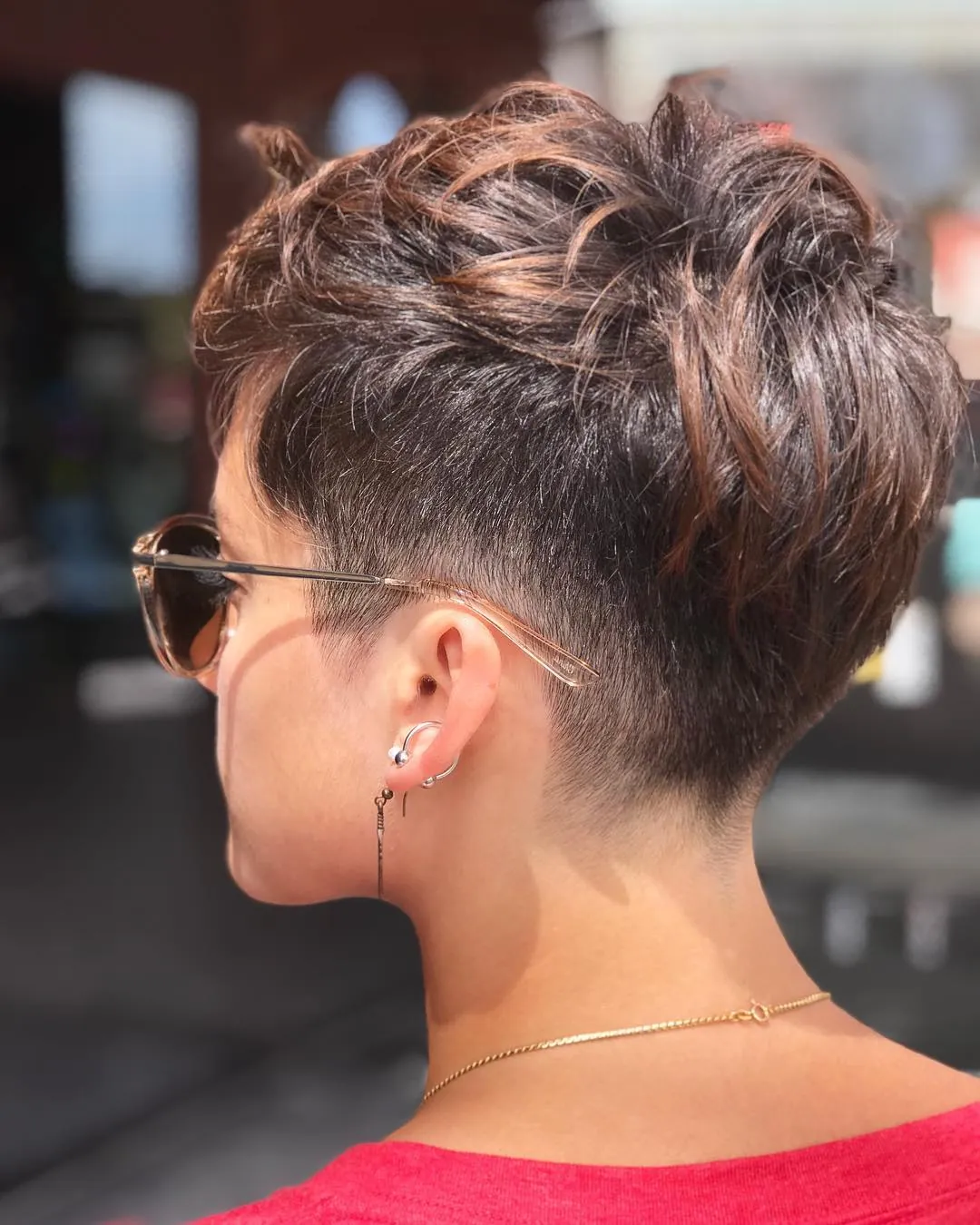 Undercut pixie with closely shaved sides and a longer textured top