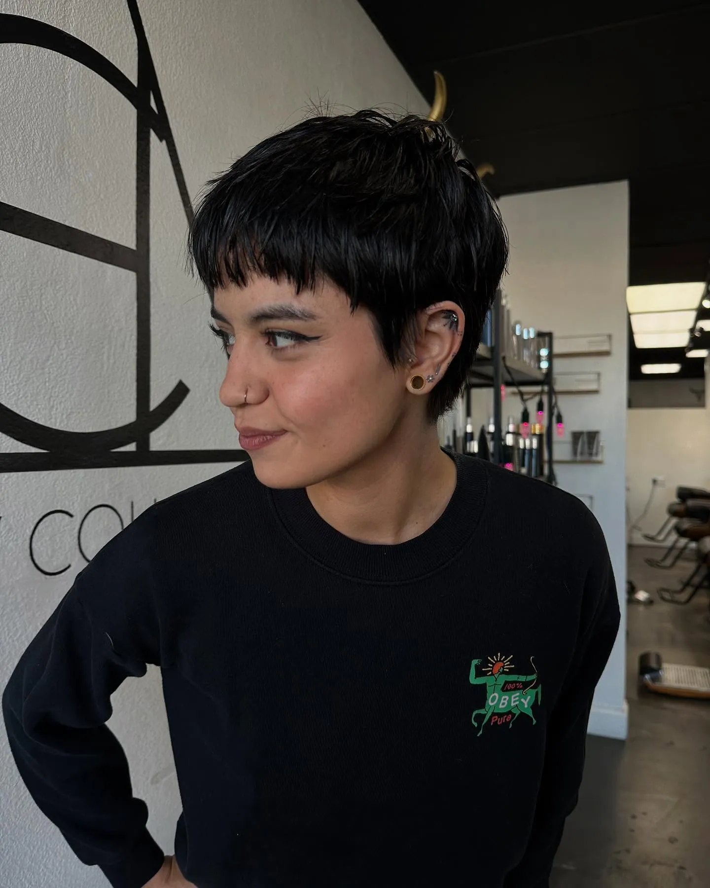 Dark pixie with a blunt micro fringe and rounded cropped shape