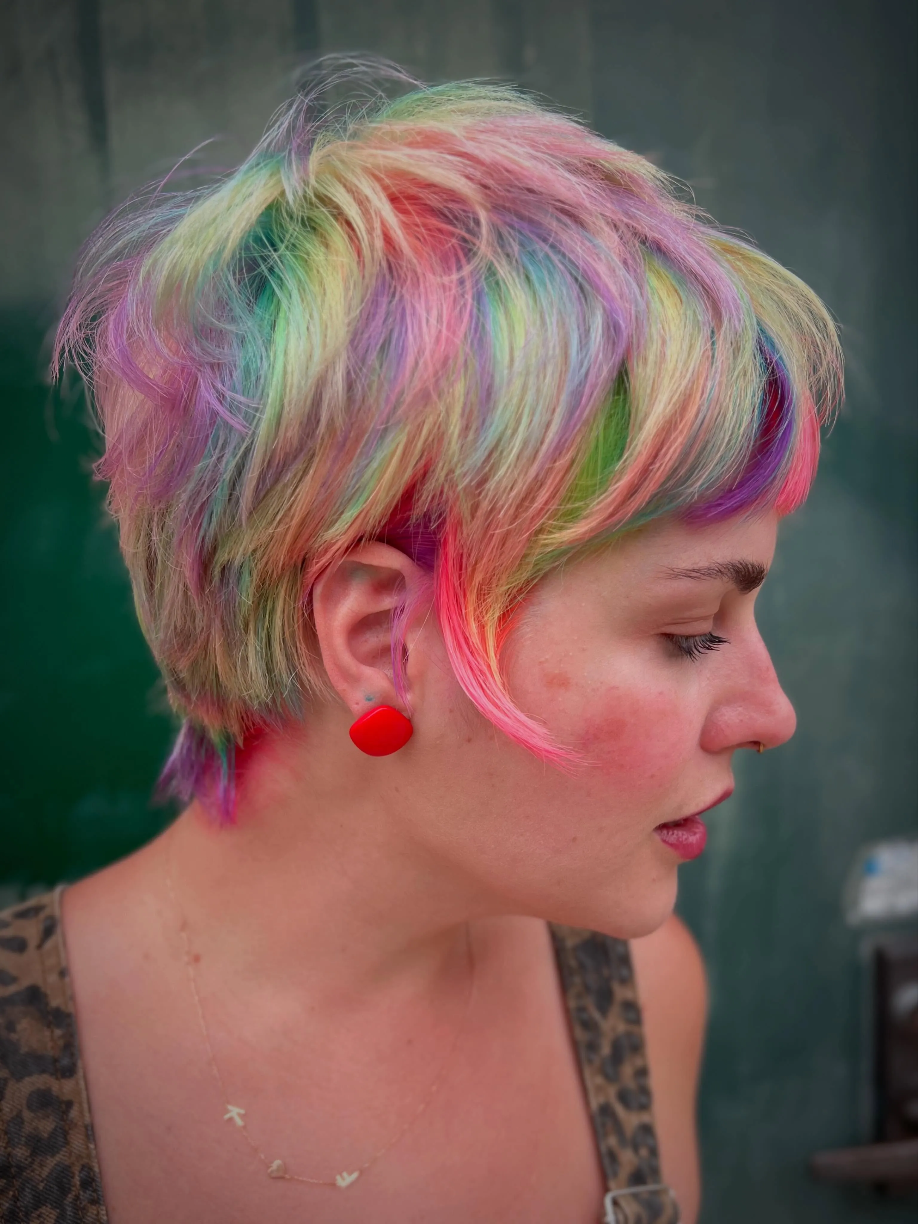 Multicolored pixie with a long side-swept fringe and short sides