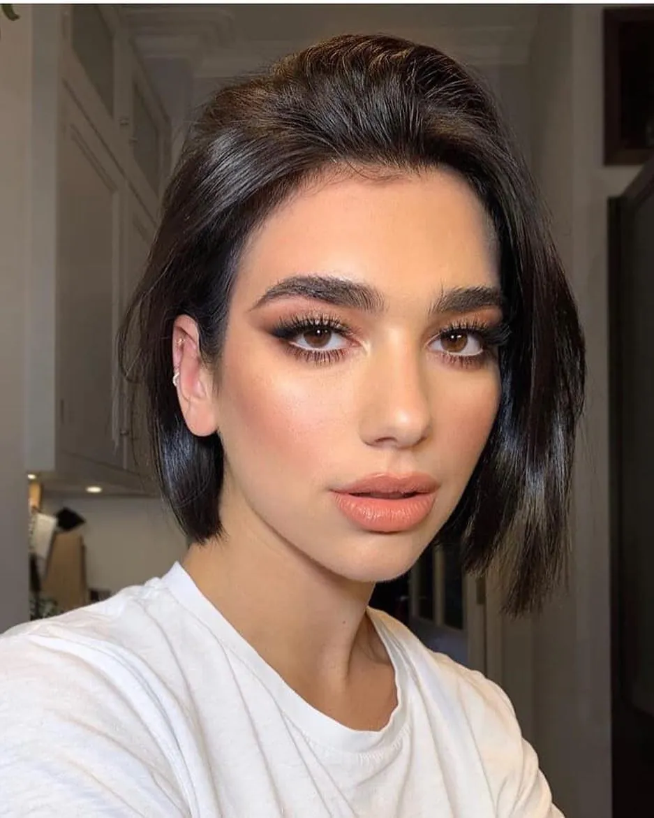 Dark short bob slicked back from the face
