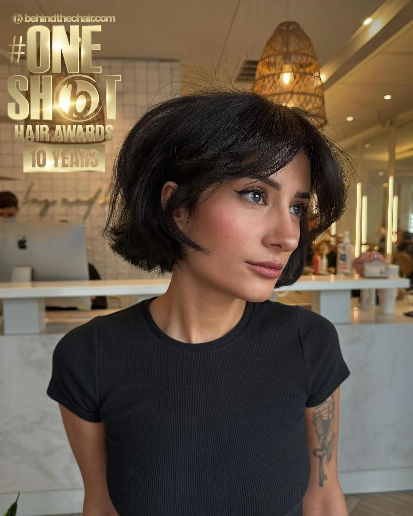Curved black Prada bob with soft side part