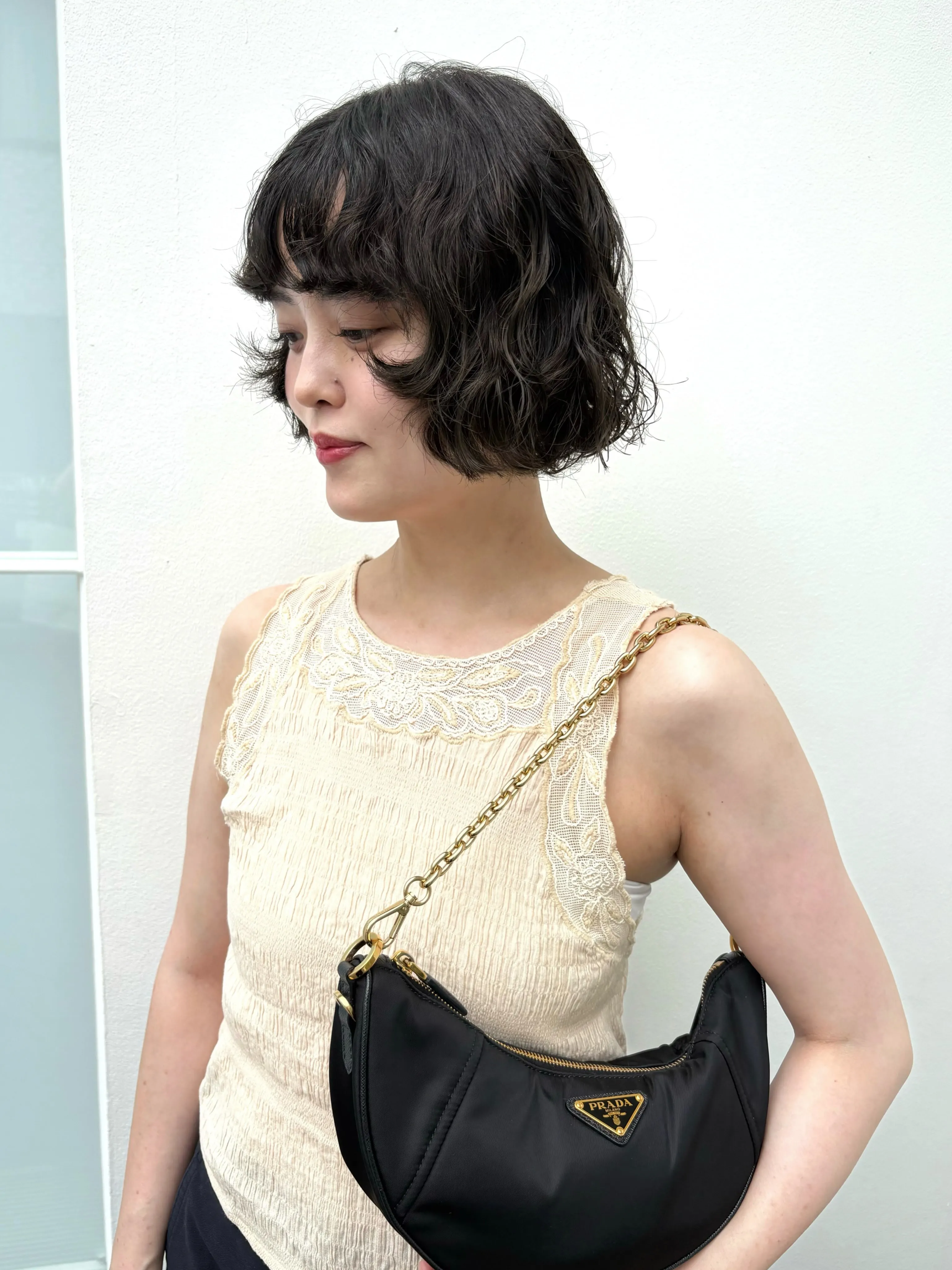 Short black Prada bob with soft waves
