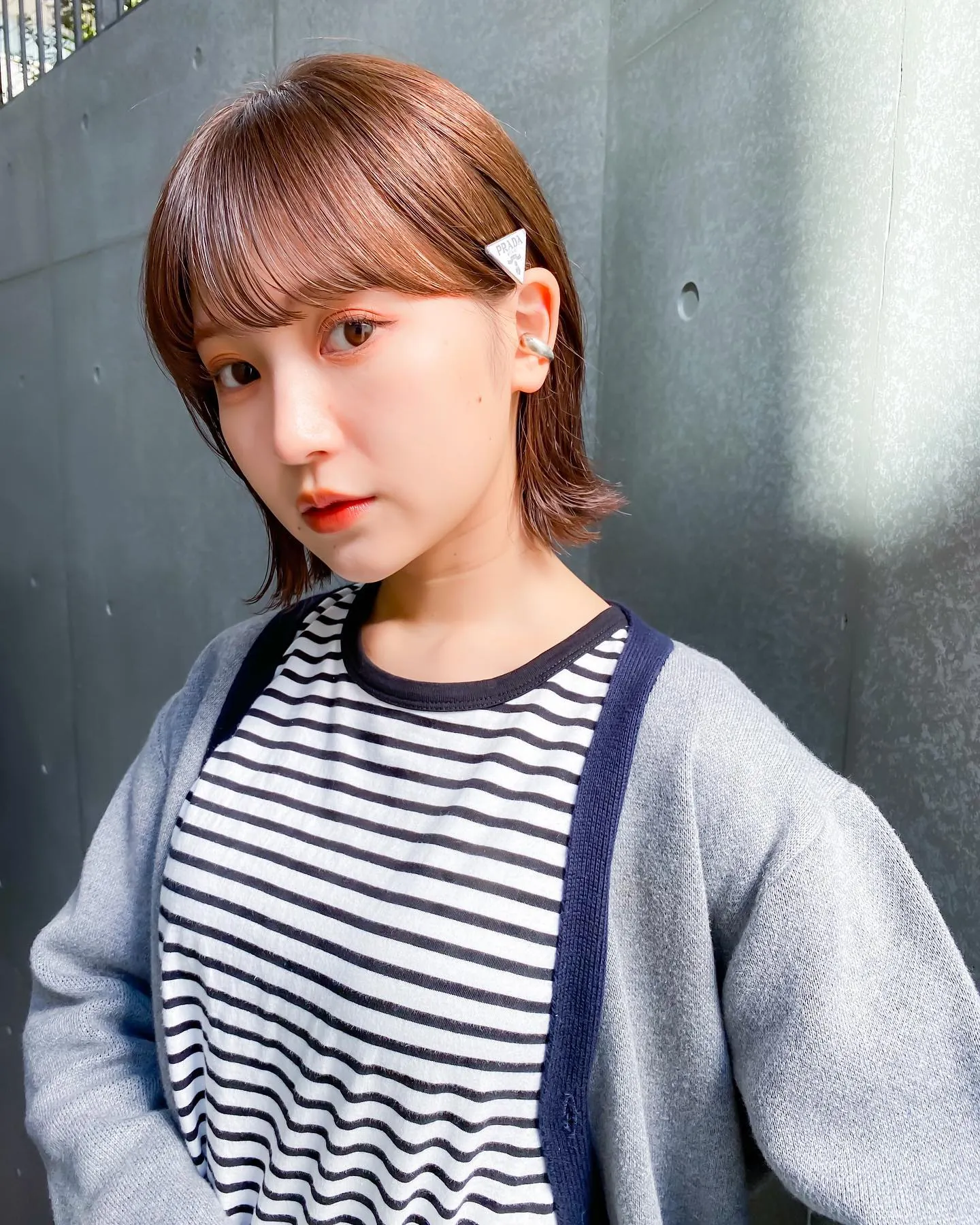 Short Prada bob with full fringe and tucked sides