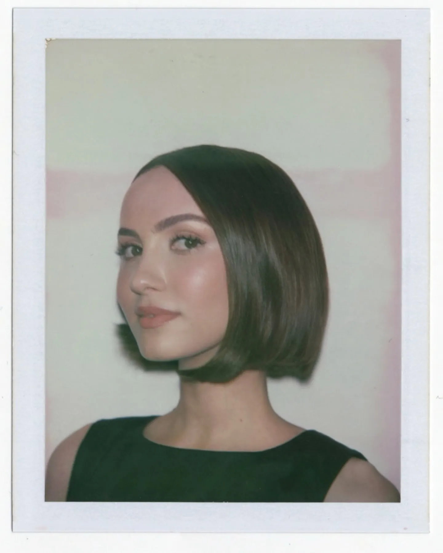 Classic dark Prada bob with centre part and curved jawline