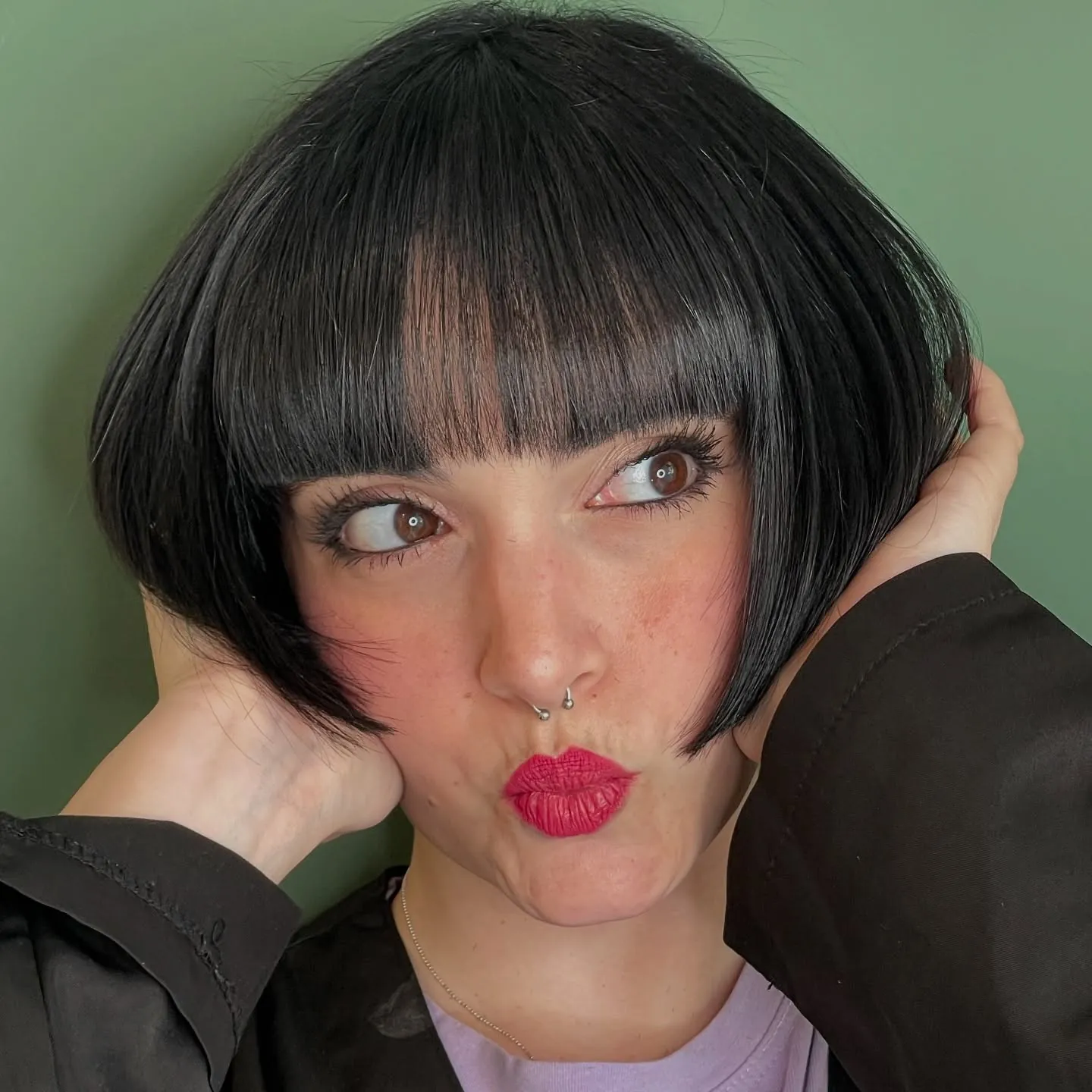 Rounded black Prada bob with full blunt fringe