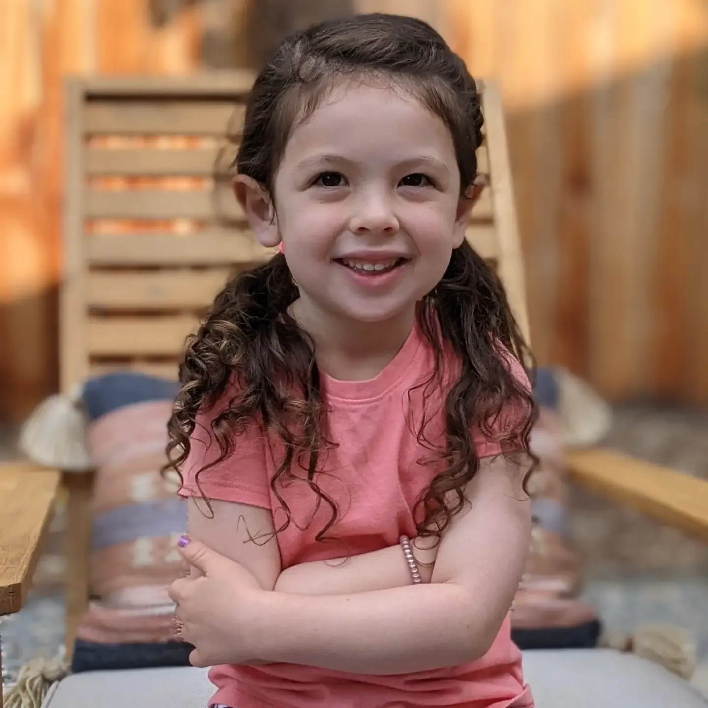 Low curly pigtails with a neat center part
