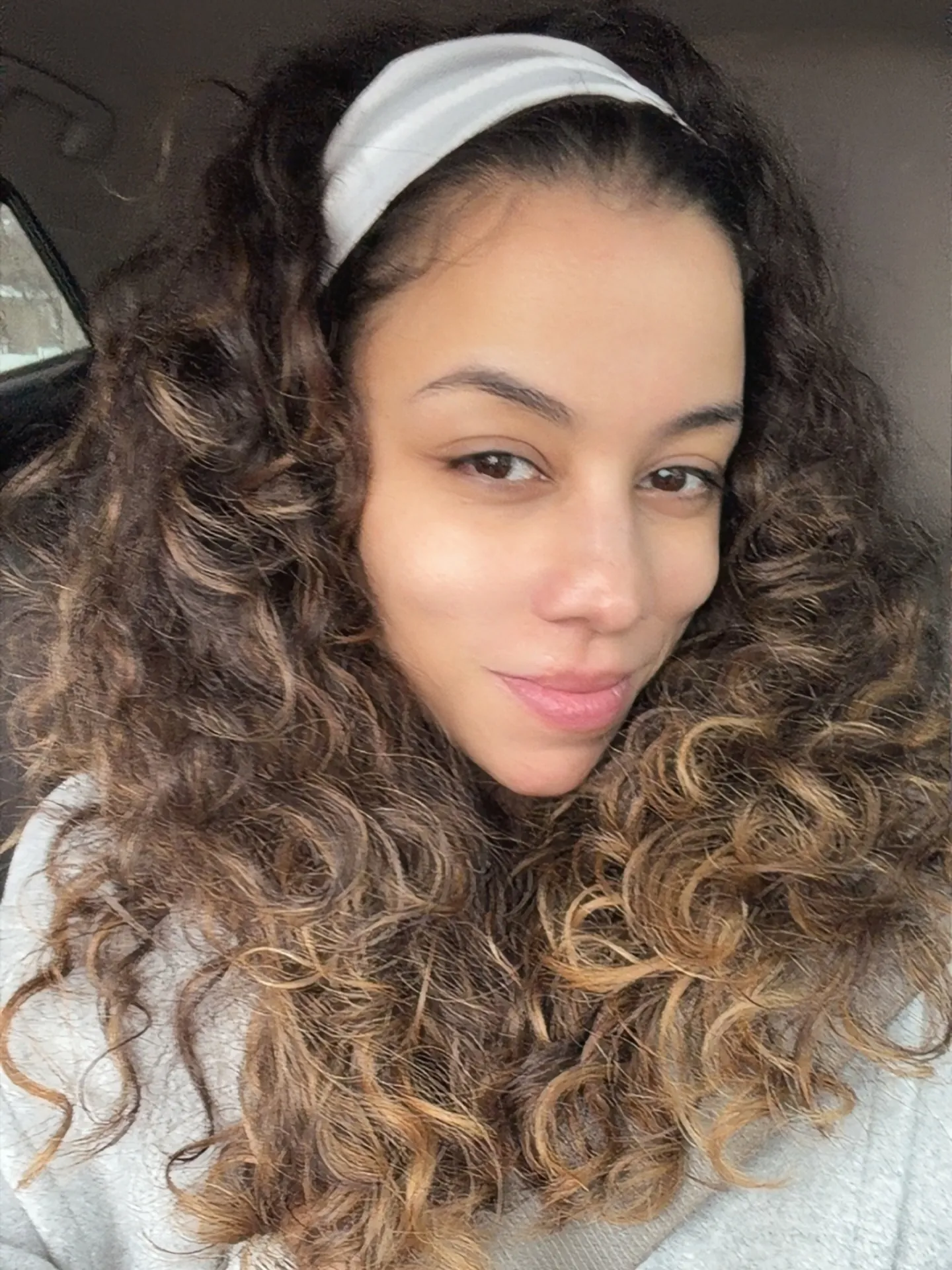 Voluminous curls held back with a wide headband