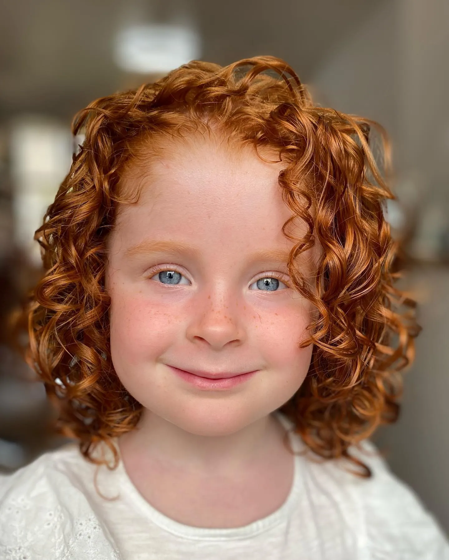 Short copper curly bob with defined ringlets