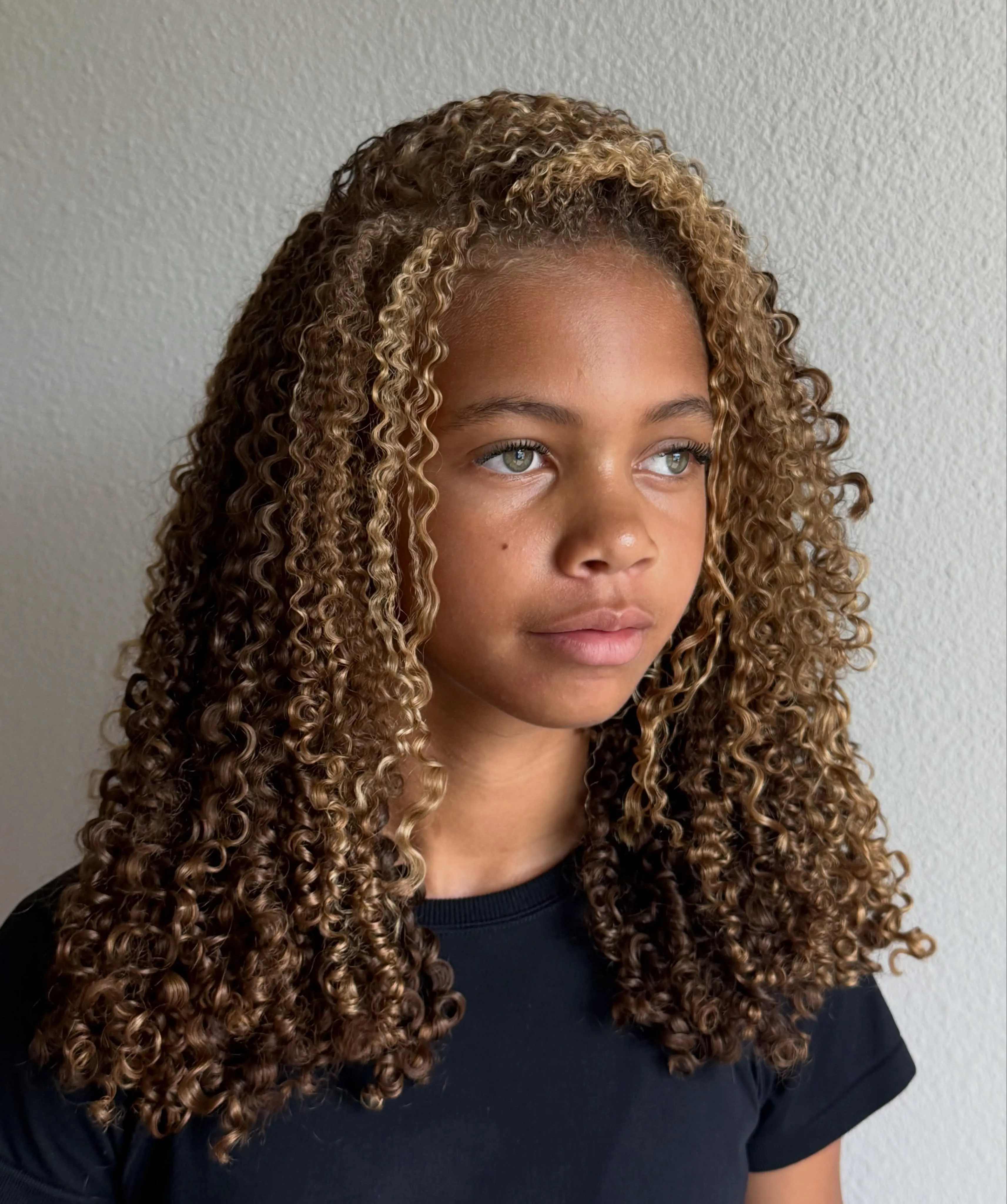 Shoulder-length defined ringlets with a center part