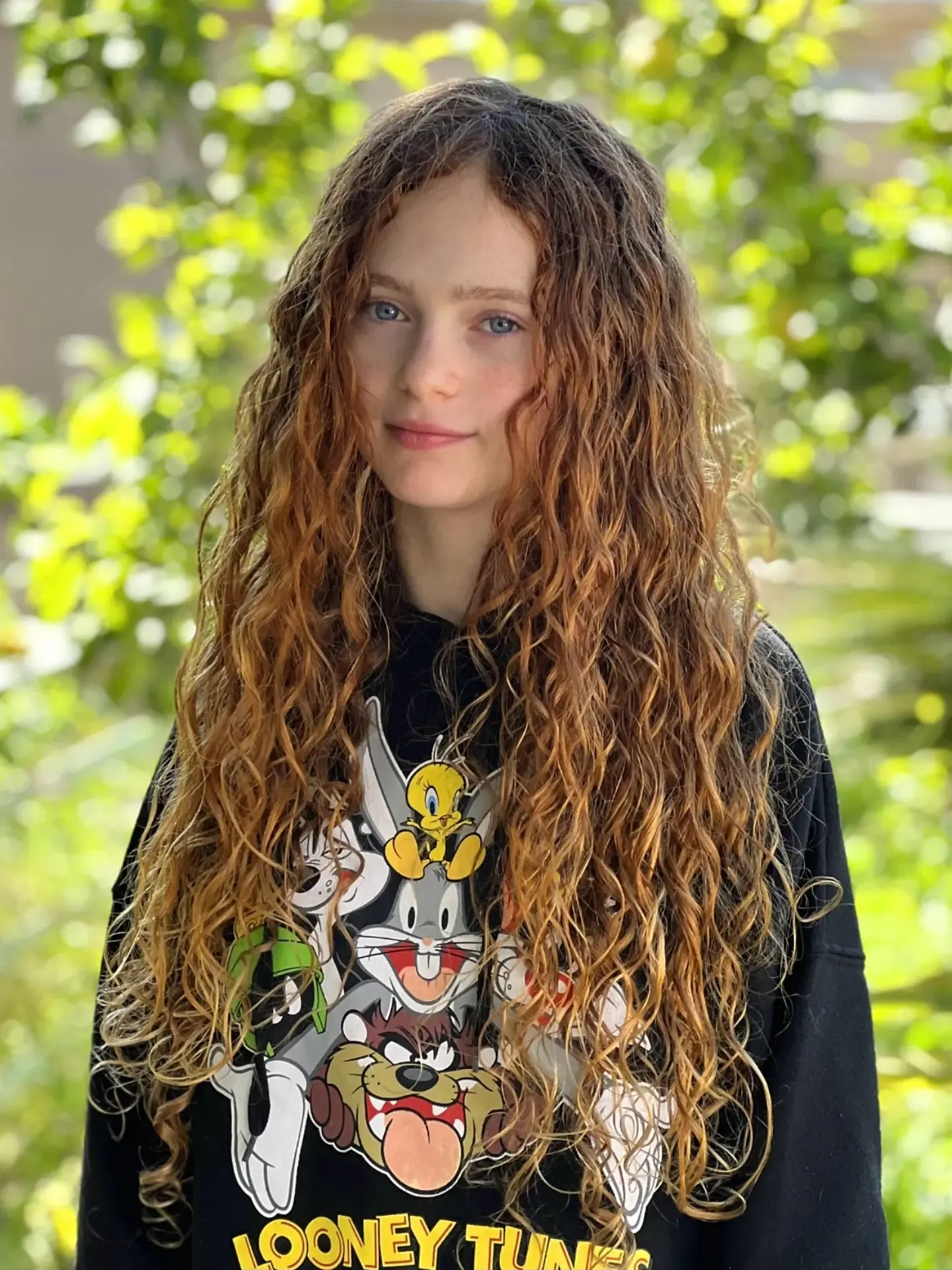 Long loose curls with a natural center part