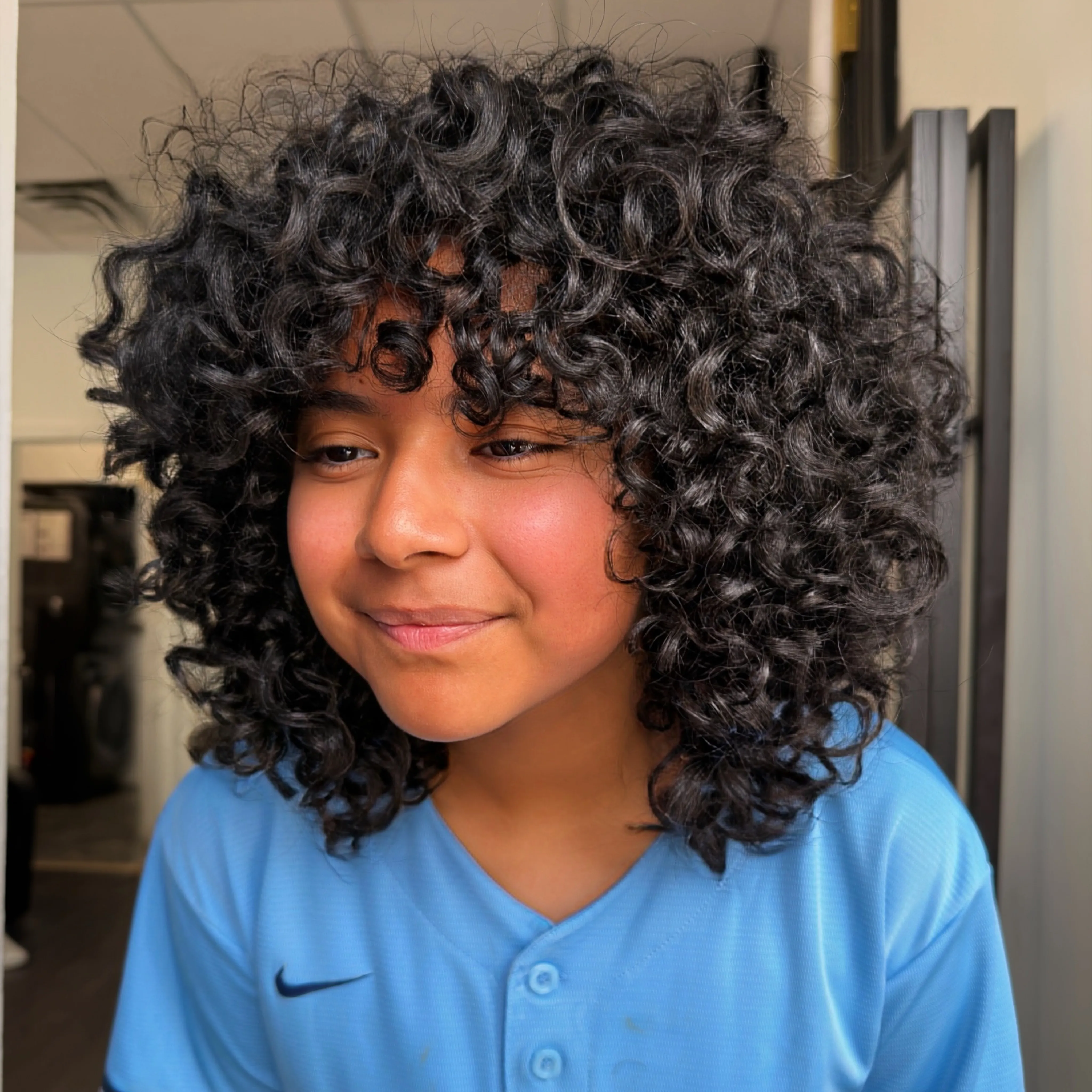 Curly shag with full bangs and rounded volume