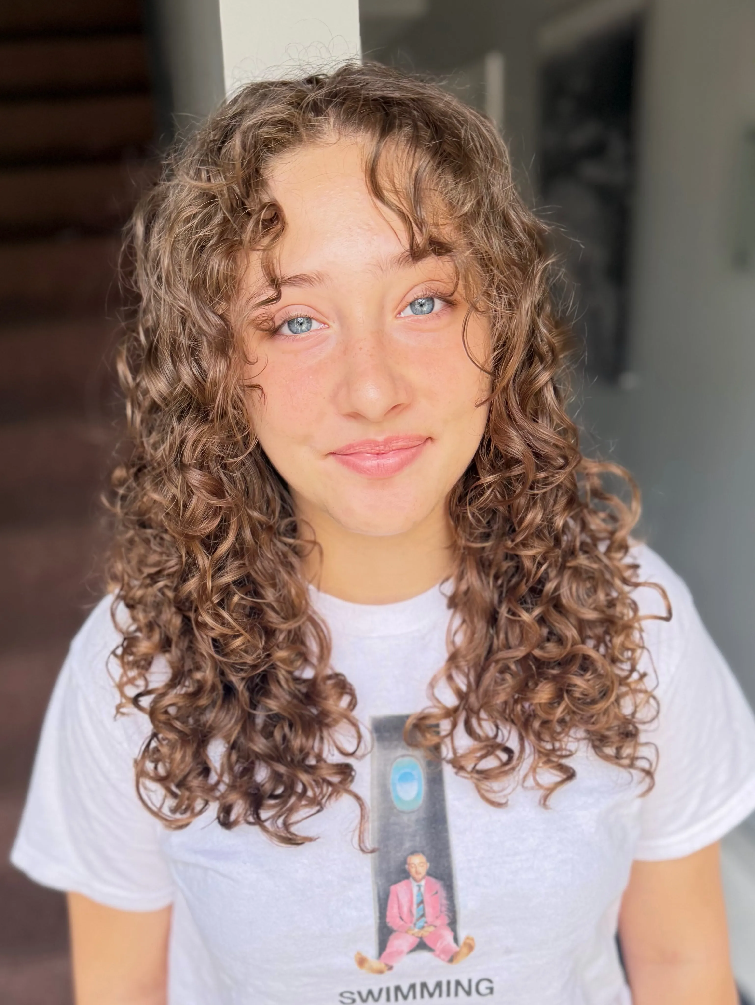 Medium-length center-part ringlets with face-framing curls