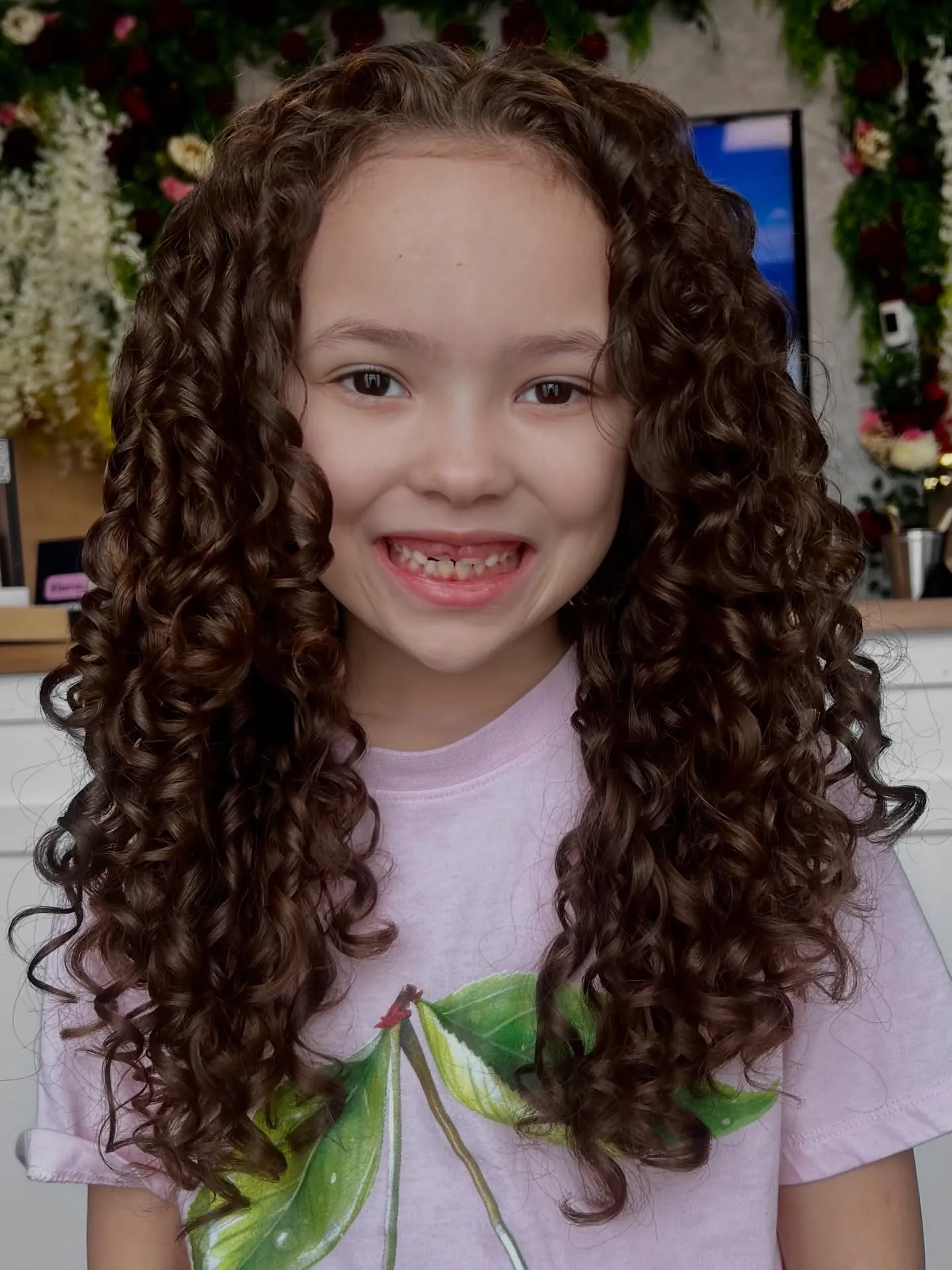 Long dark spiral curls with a center part