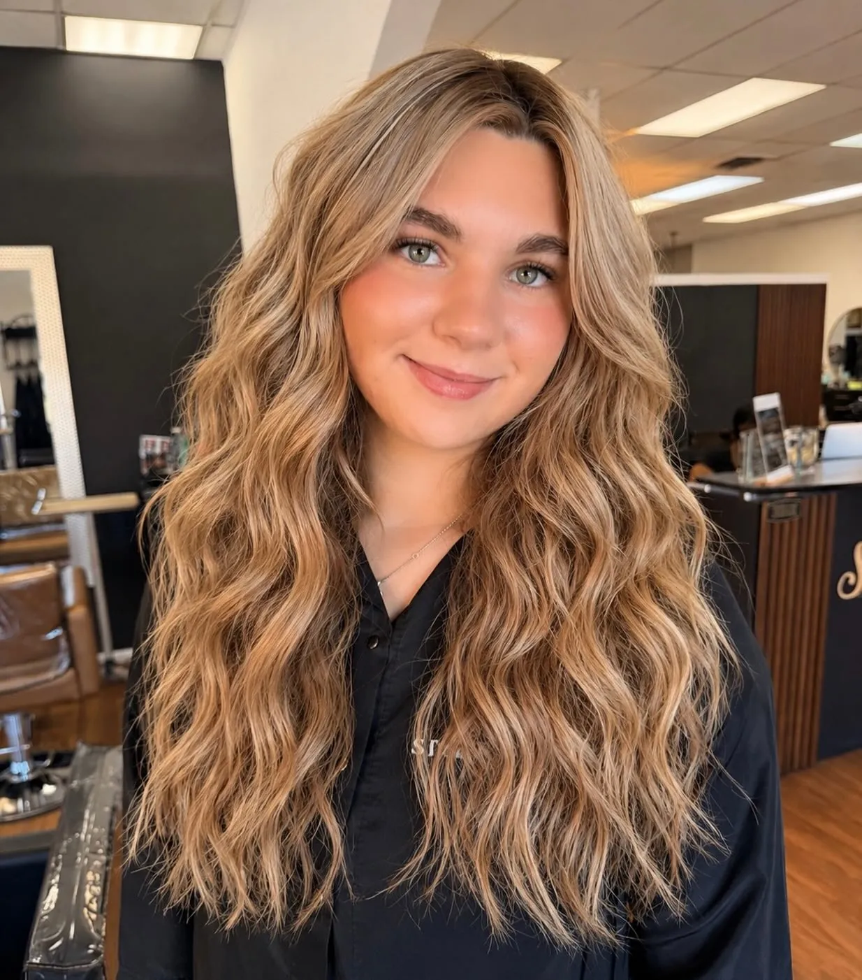 Long defined blonde waves with centre part