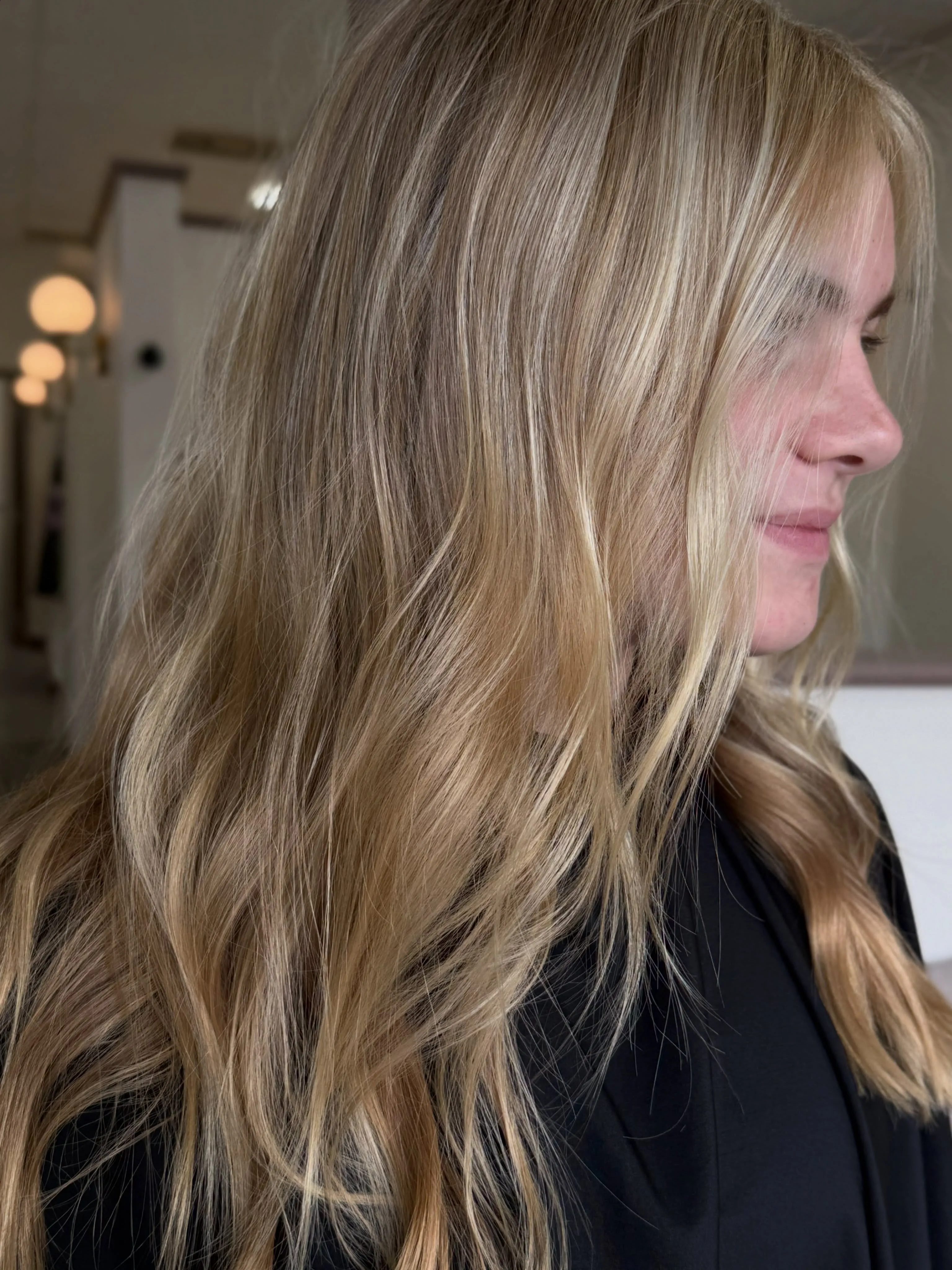 Long blonde waves with soft face-framing layers