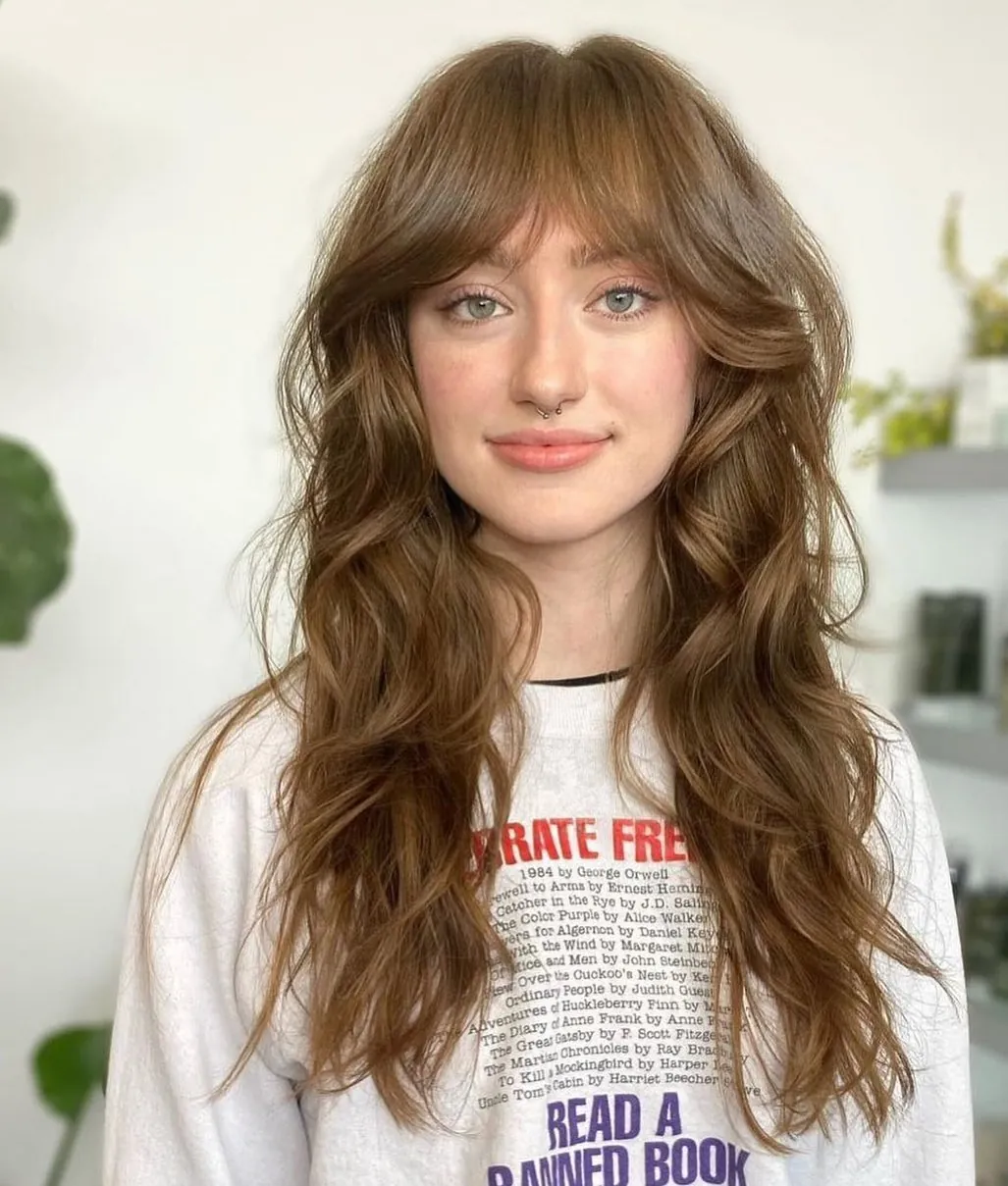 Long brown waves with soft curtain bangs