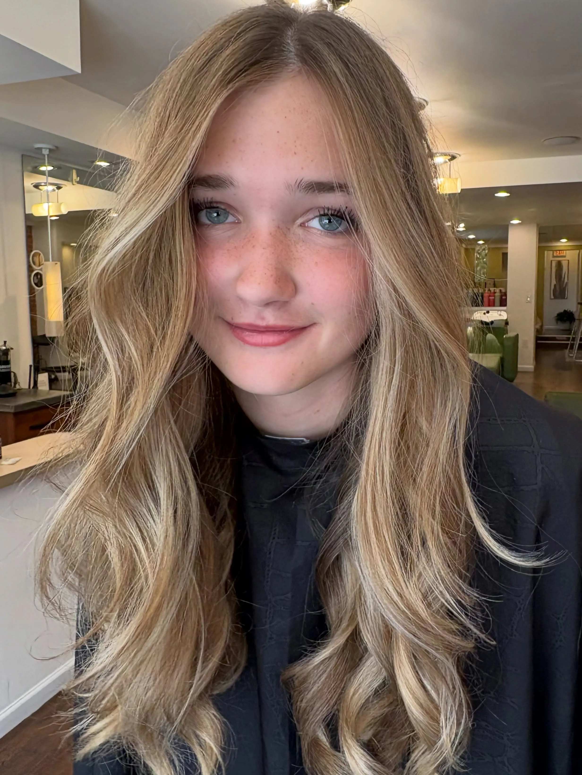 Long blonde waves with a middle part
