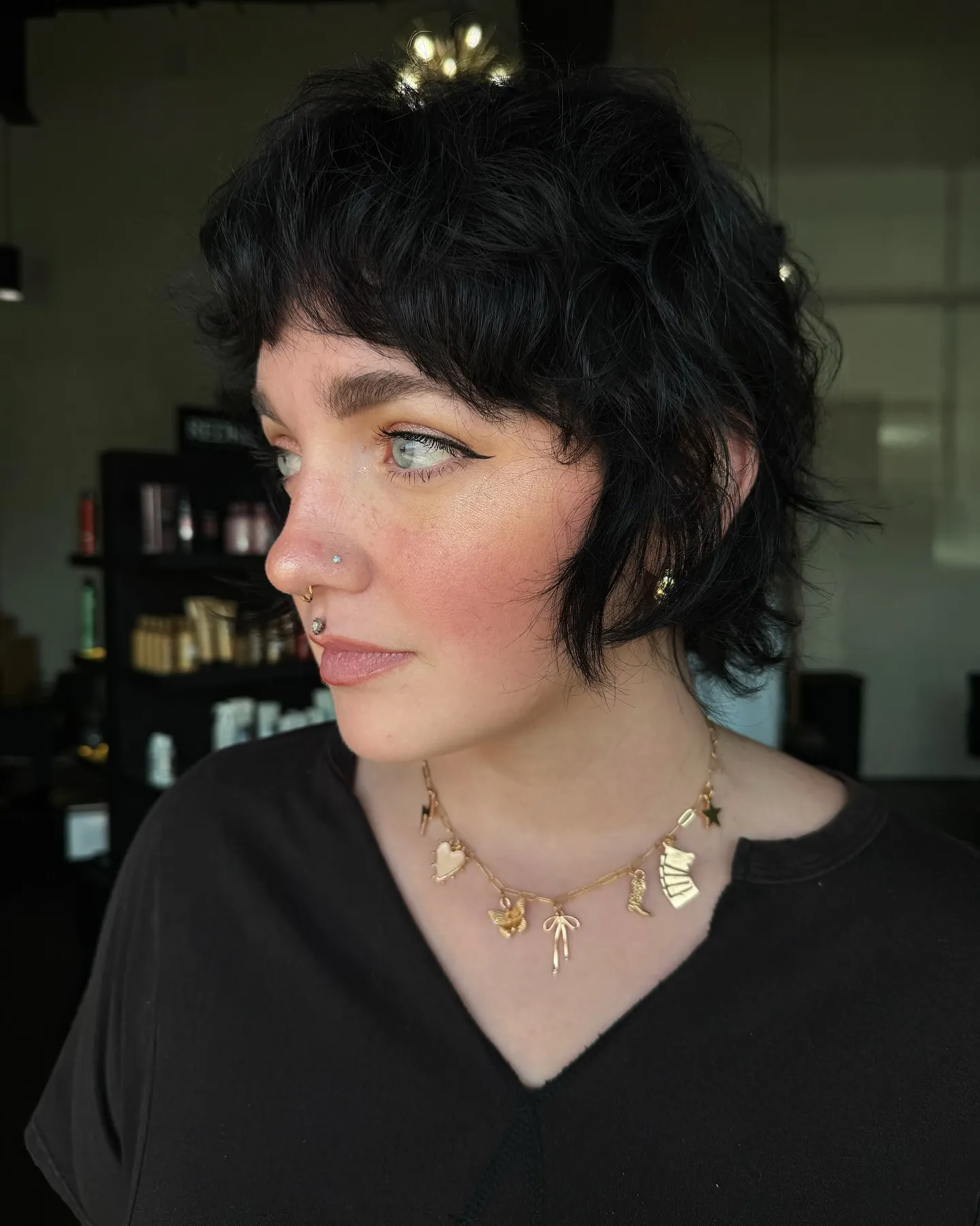 Choppy dark shaggy pixie with short fringe and longer nape