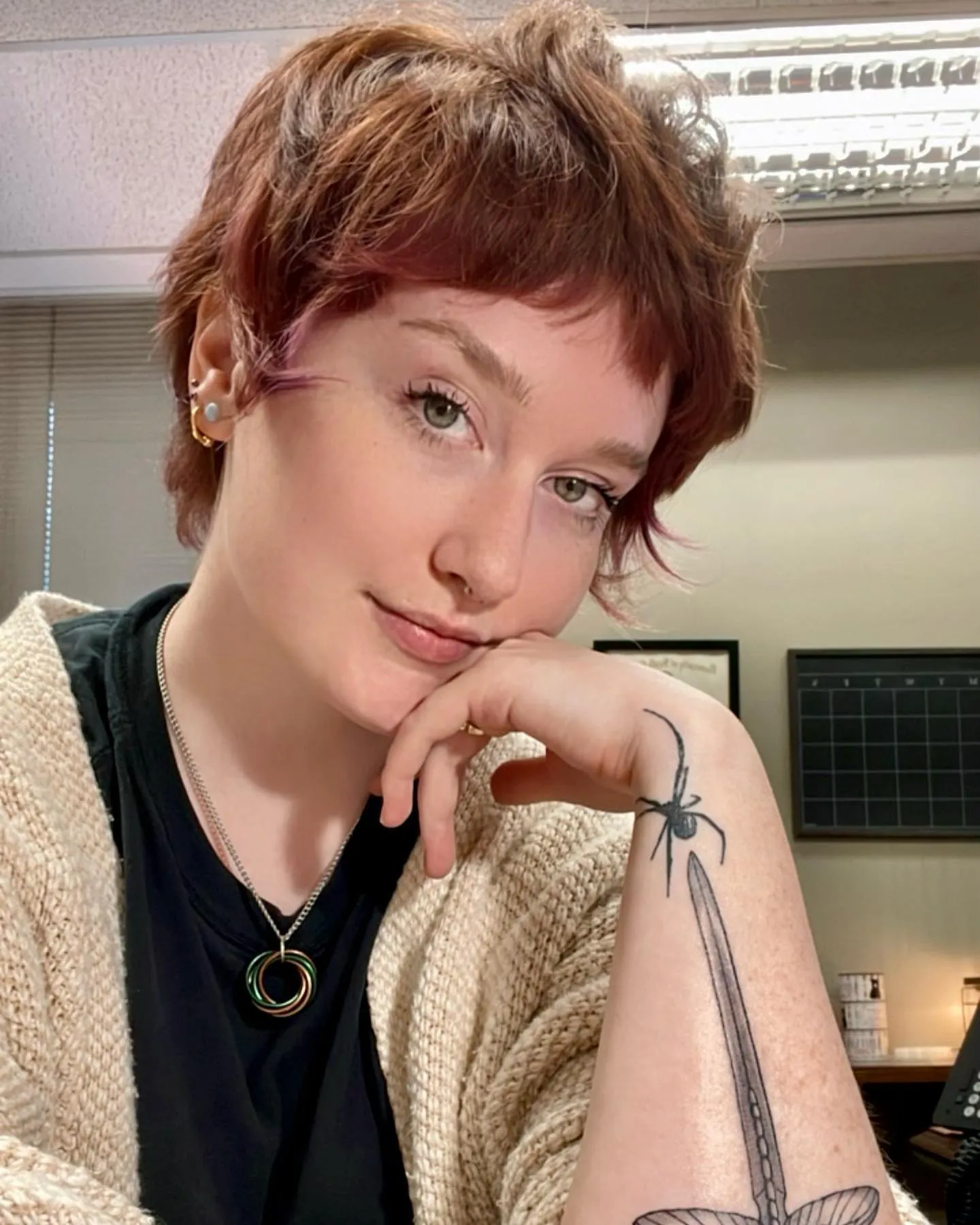 Short copper shaggy pixie with textured crown and tiny fringe