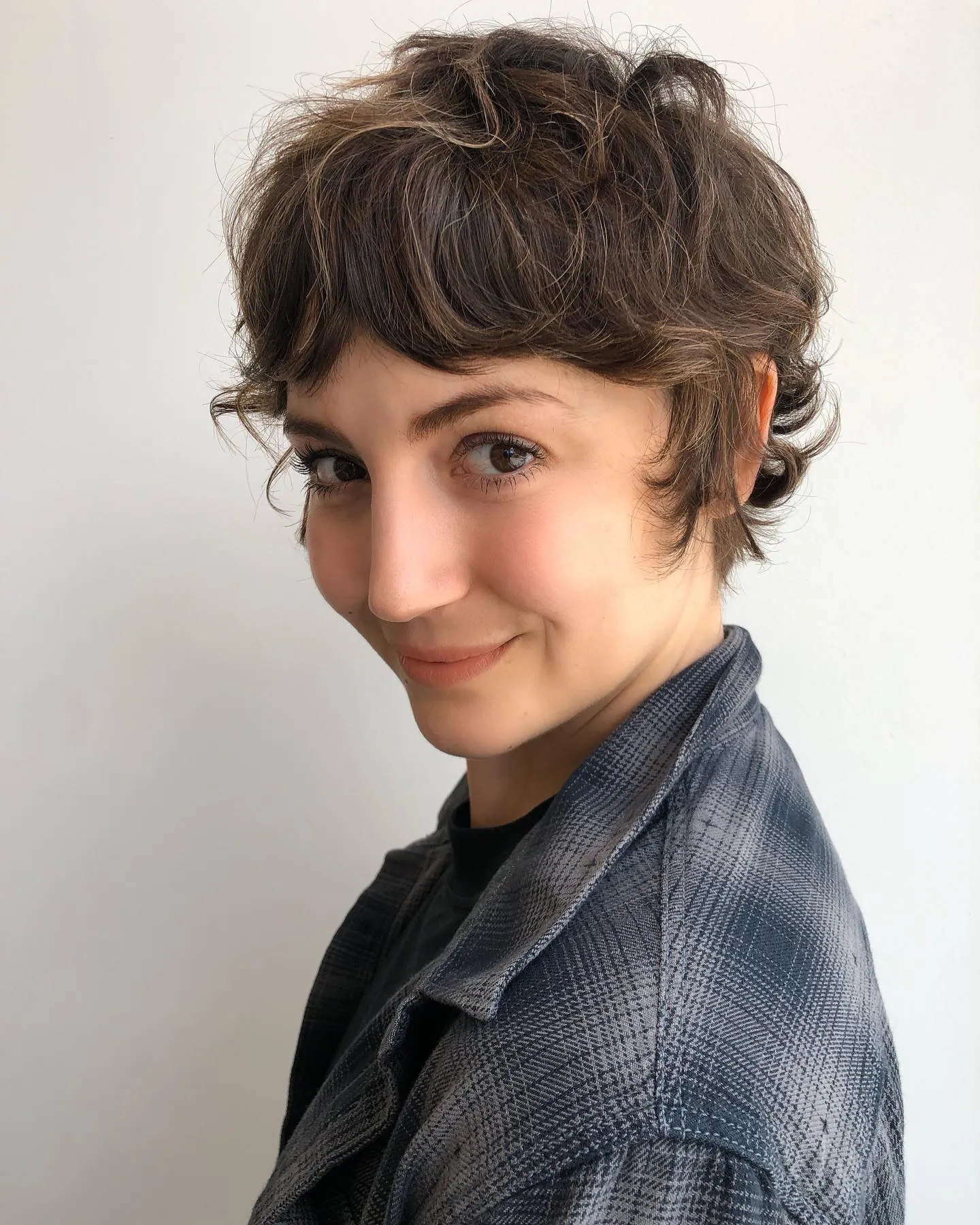 Curled shaggy pixie with soft fringe and flipped nape
