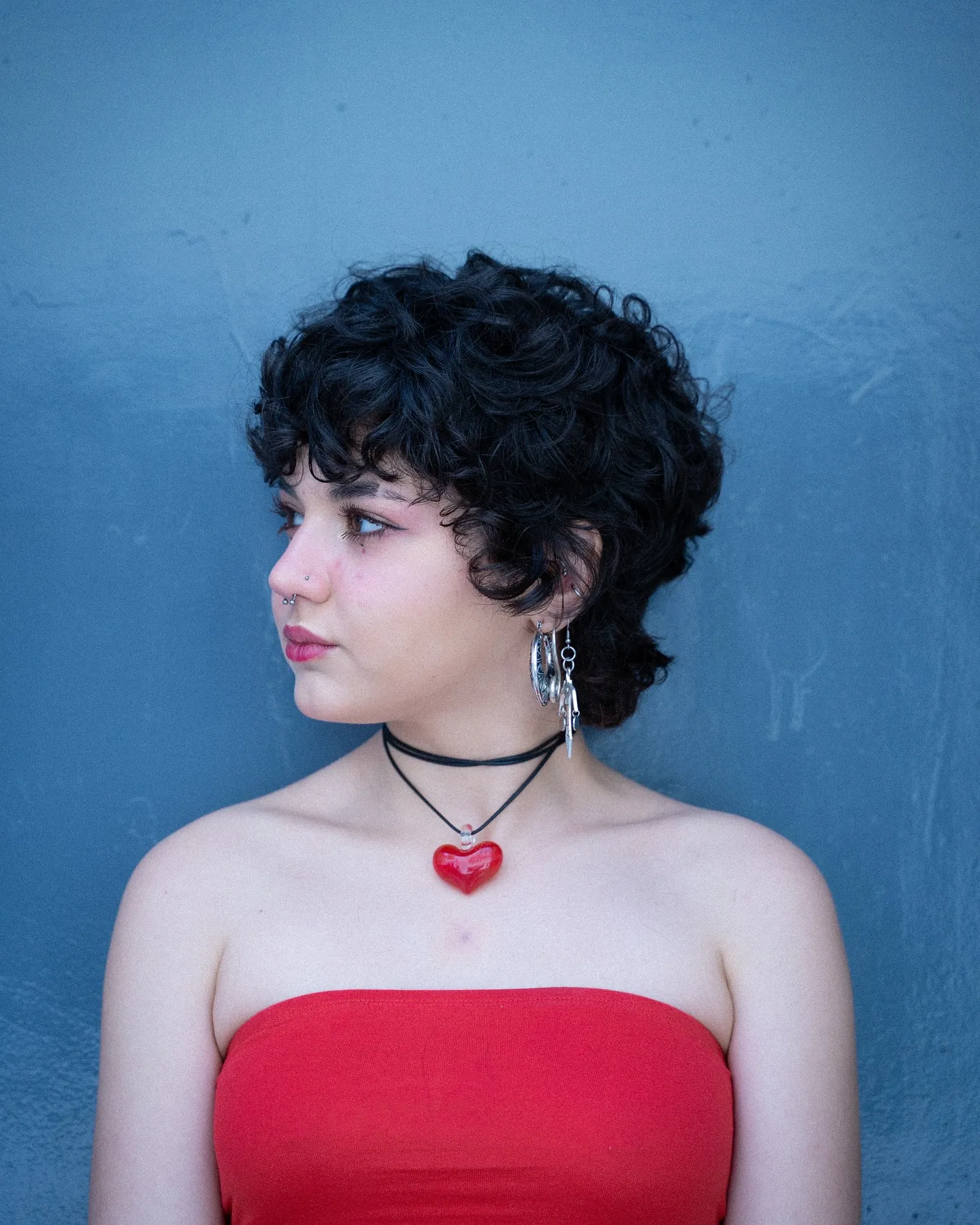 Curly shaggy pixie mullet with rounded top and longer nape