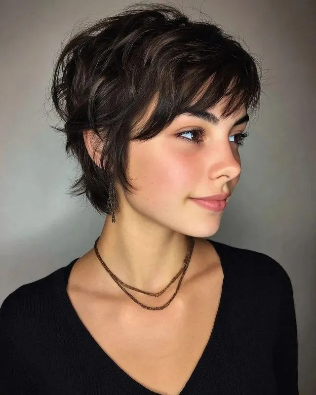 Shaggy pixie with long side fringe and textured nape