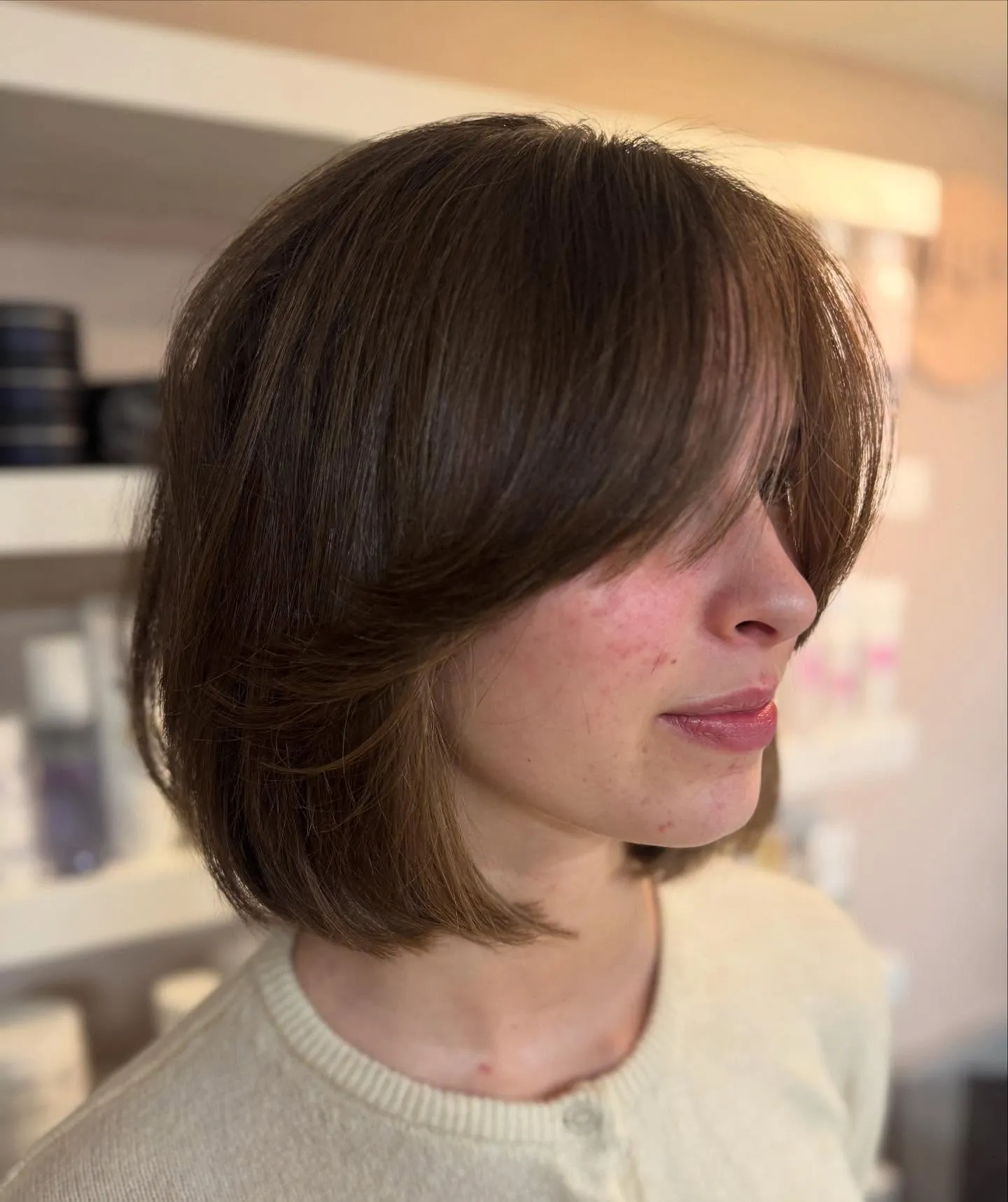 Rounded bob with long curtain bangs across the face