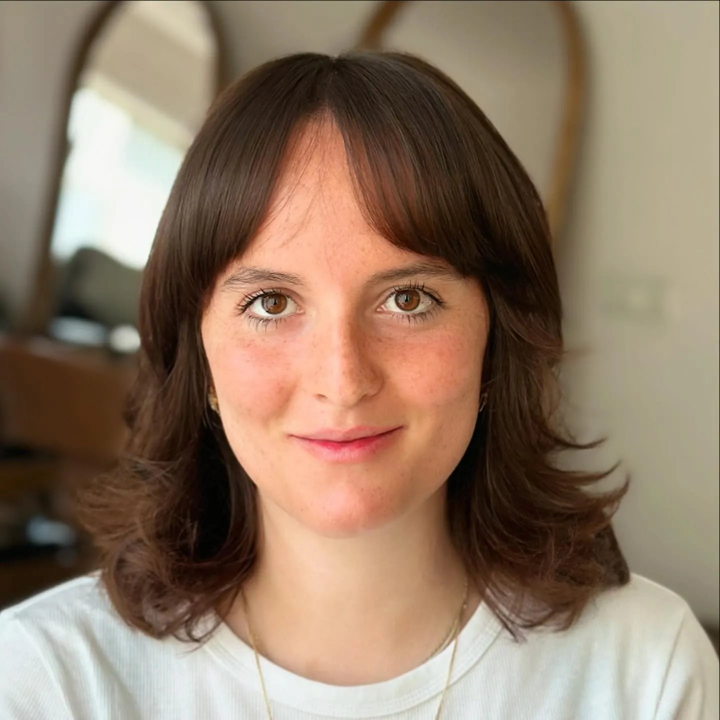 Layered shoulder bob with curtain bangs and flipped ends