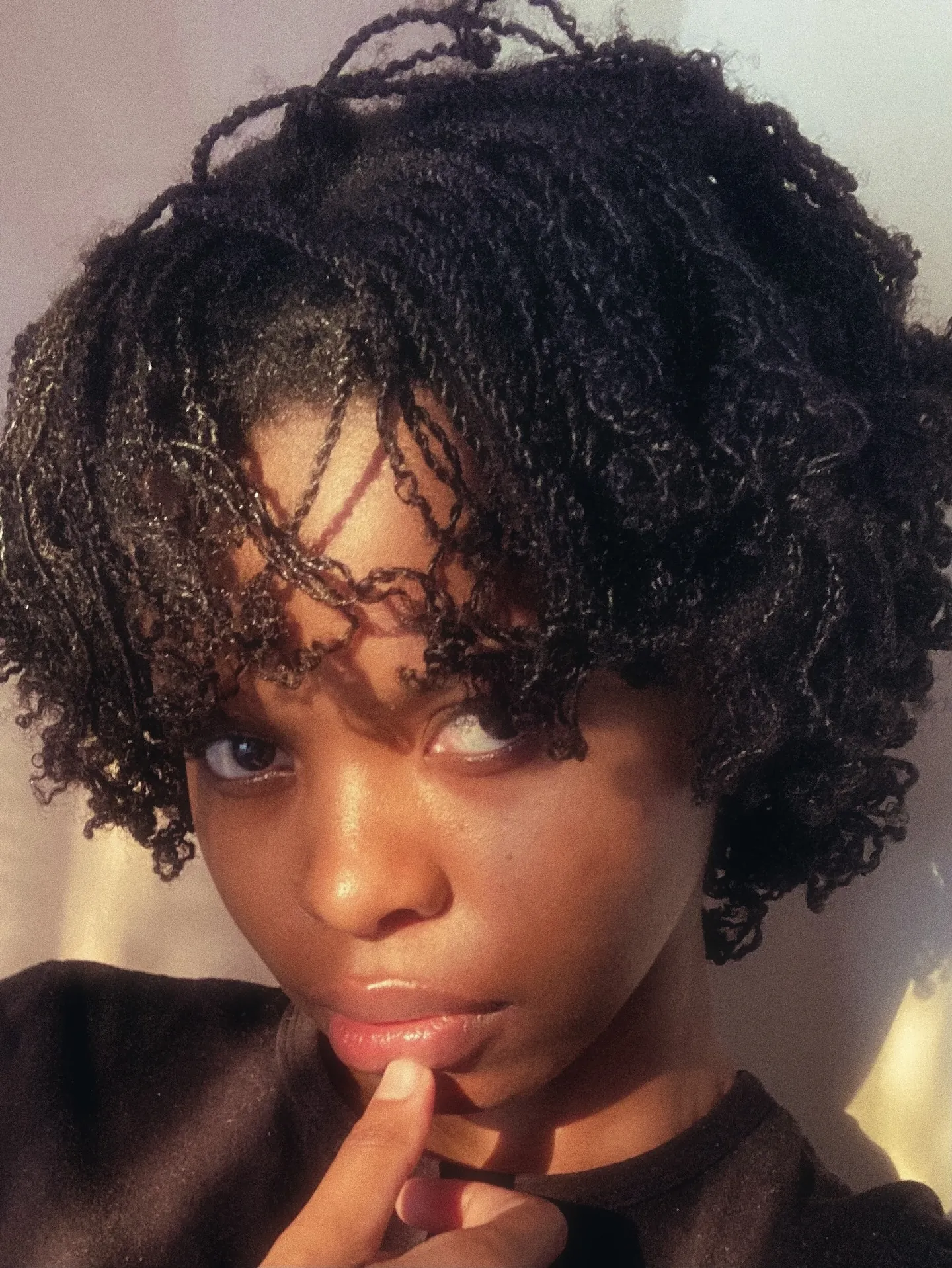 Short curly bob with several fine front mini braids