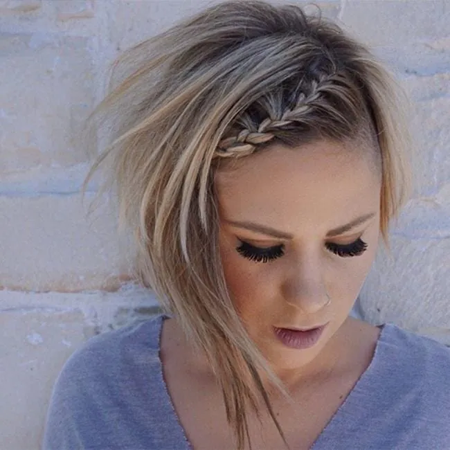 Asymmetrical short pixie with a small braid along the hairline