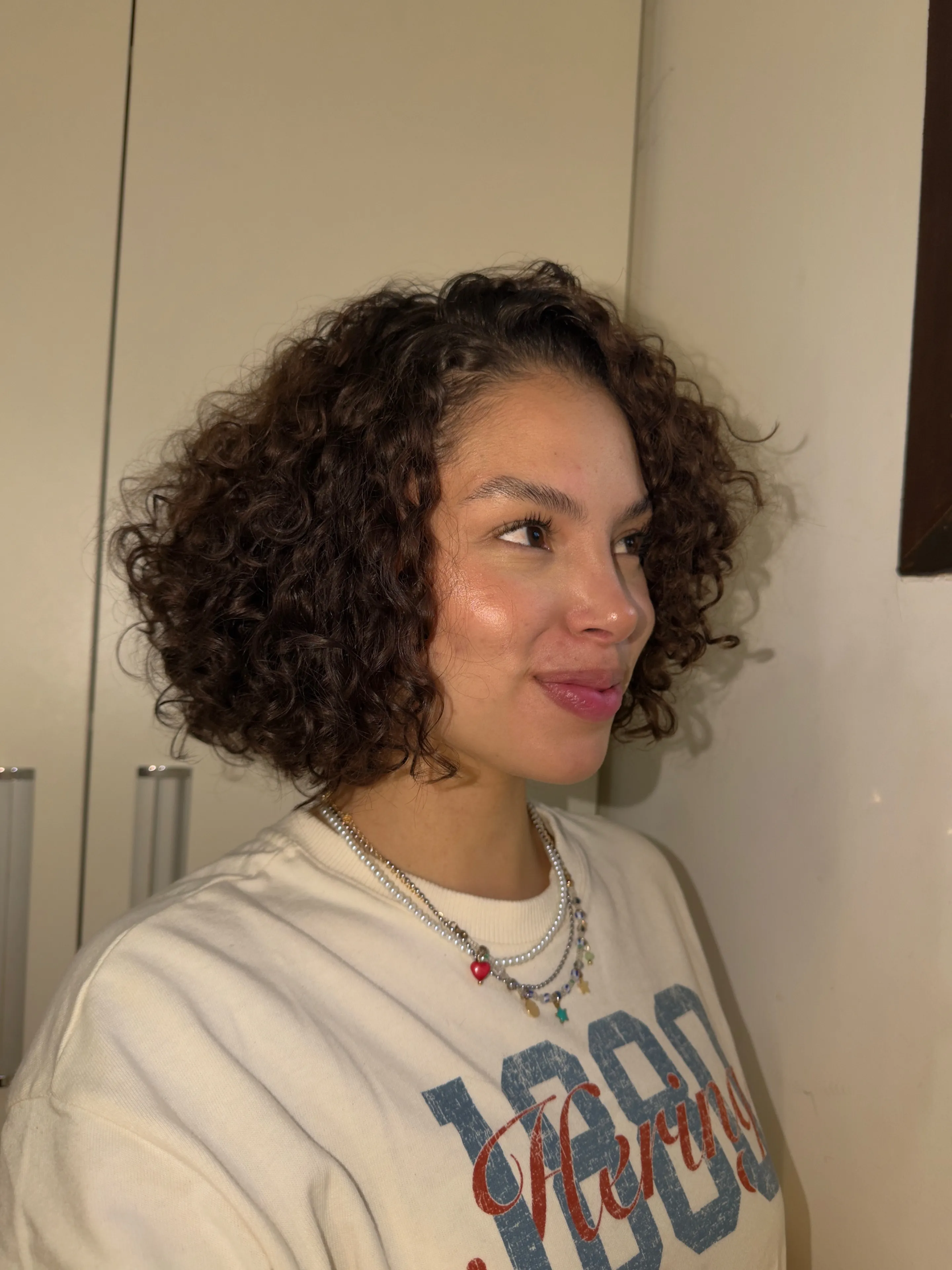 Curly bob with a subtle mini braid near the side part