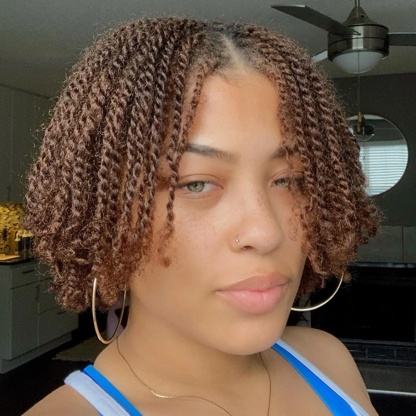 Short brown mini twist bob with center part