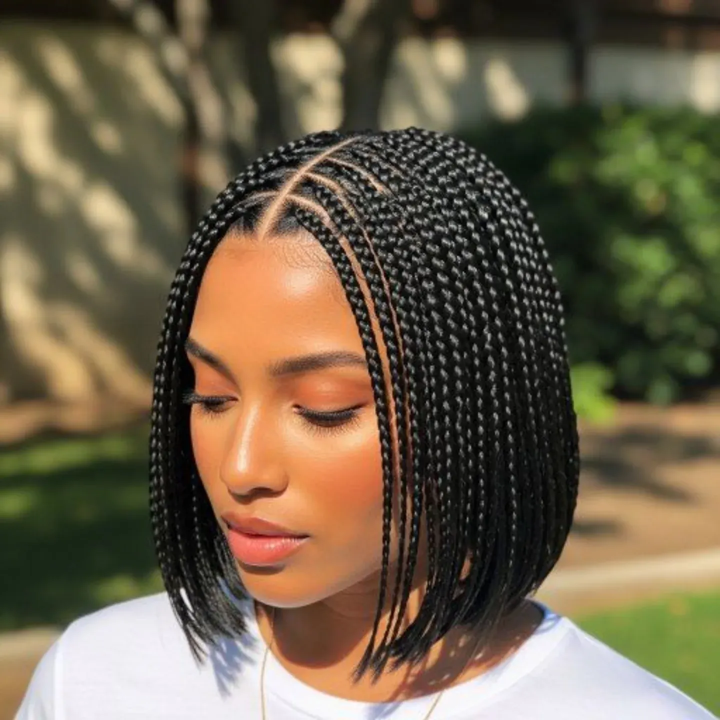 Sleek black braided bob cut around jaw length