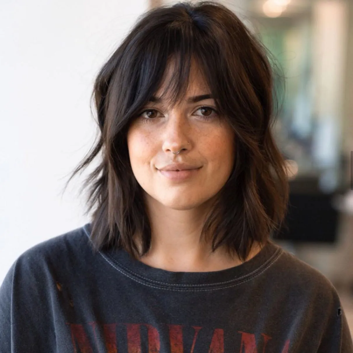 Layered shoulder-length lob with wispy curtain fringe