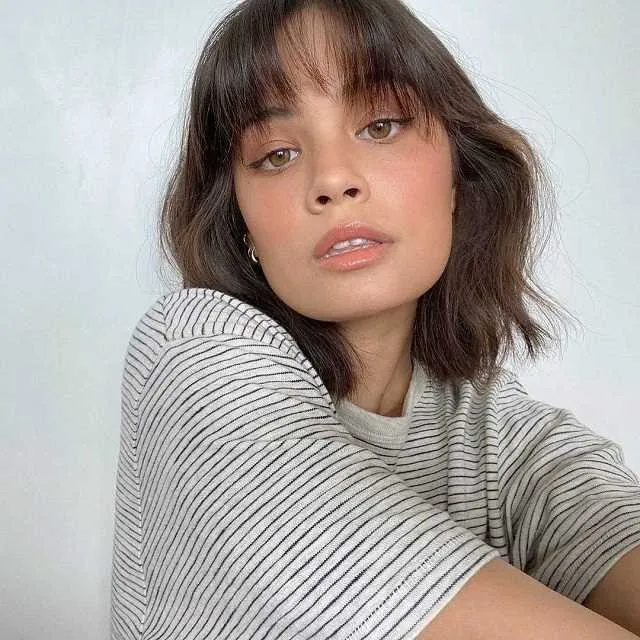 Soft shoulder-length lob with wispy bangs and loose waves