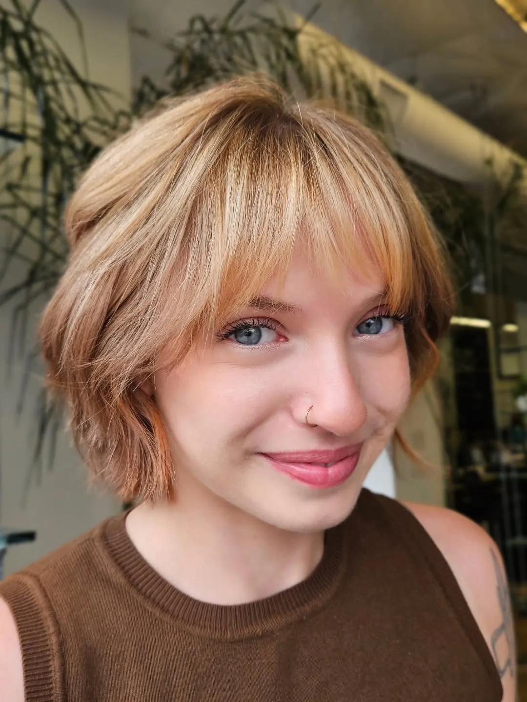 Rounded blonde bixie with soft wispy curtain fringe