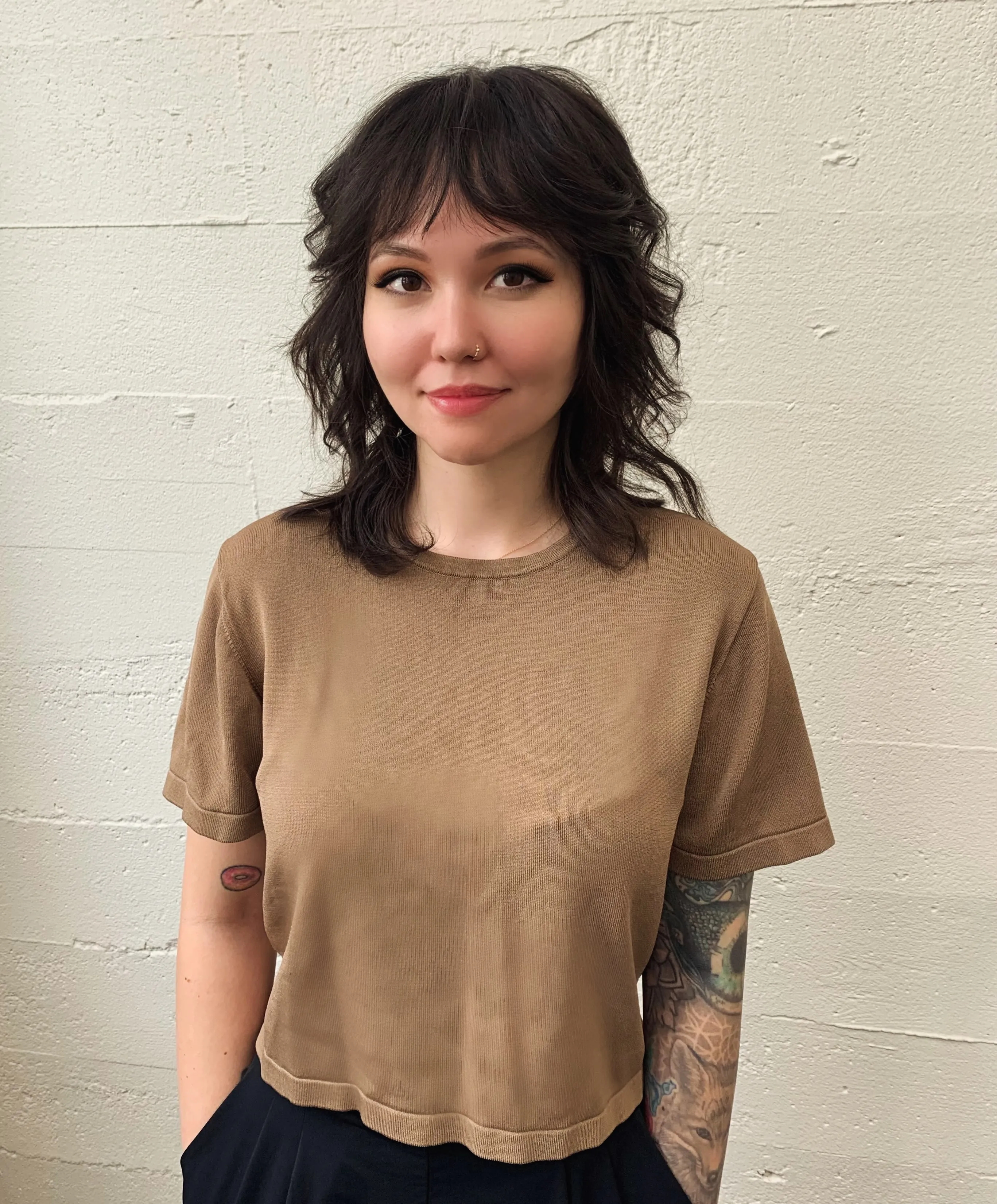 Shaggy shoulder-length cut with wispy curtain bangs