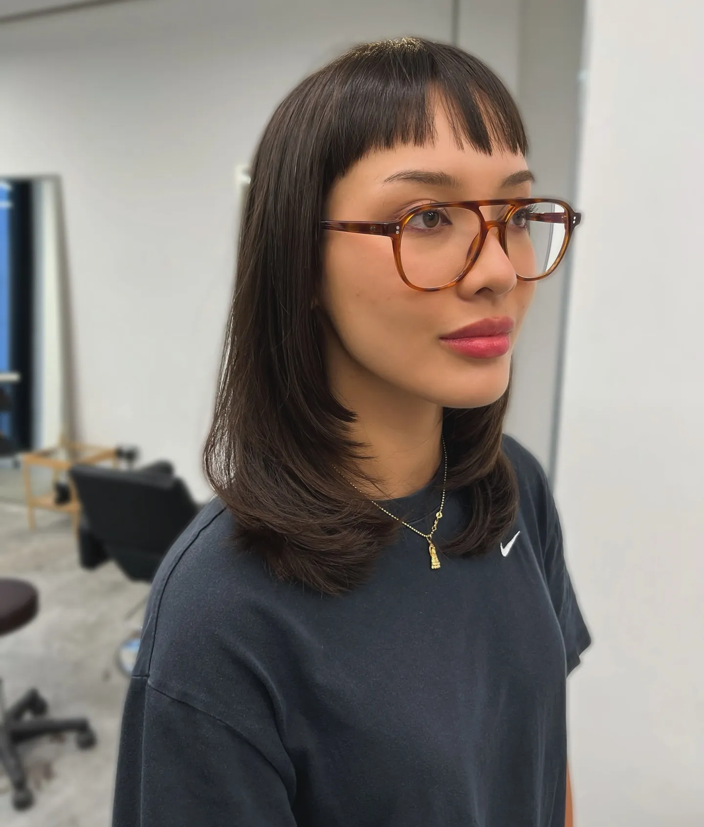 Sleek dark lob with short straight bangs