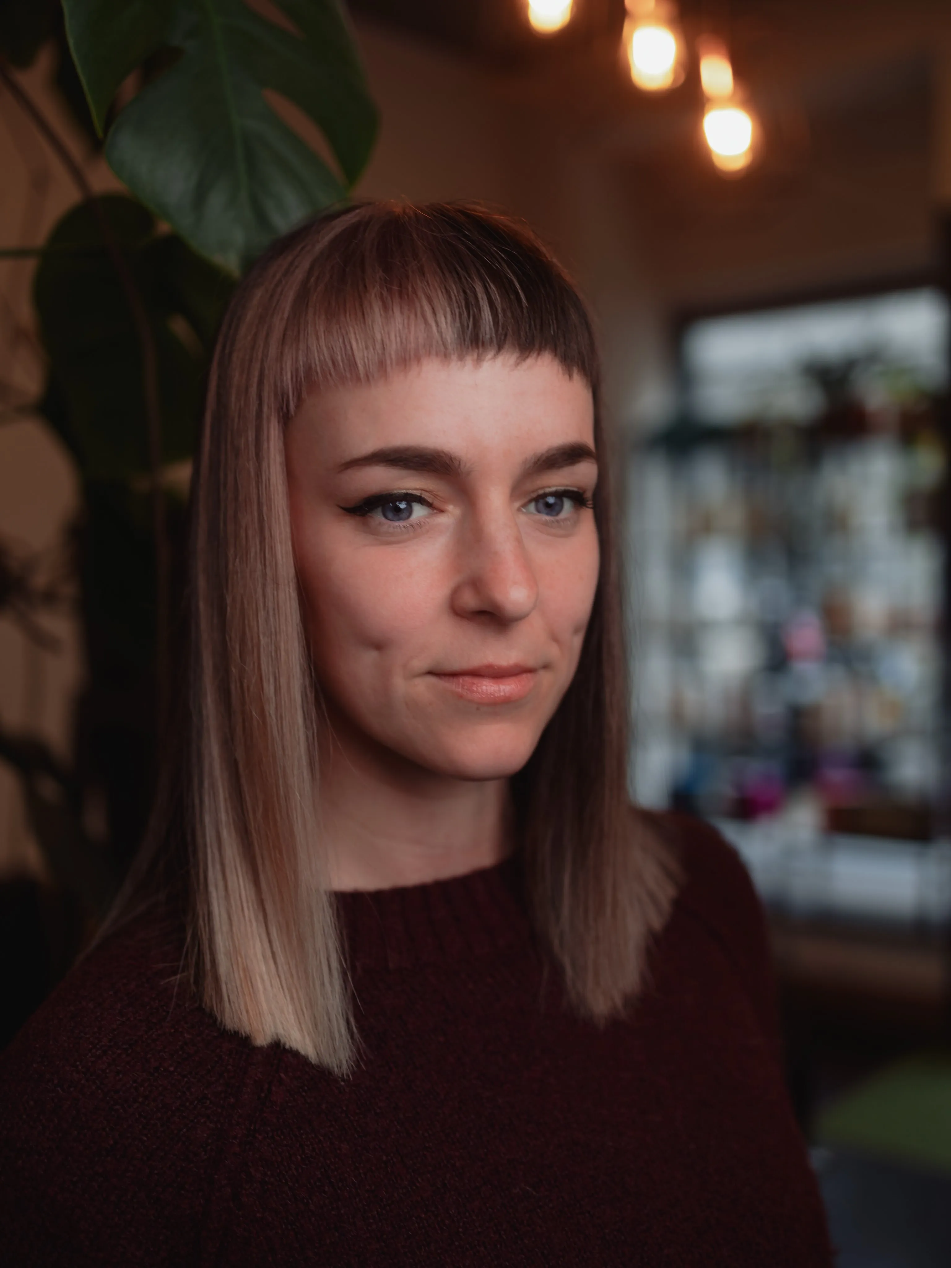 Straight auburn lob with short baby bangs