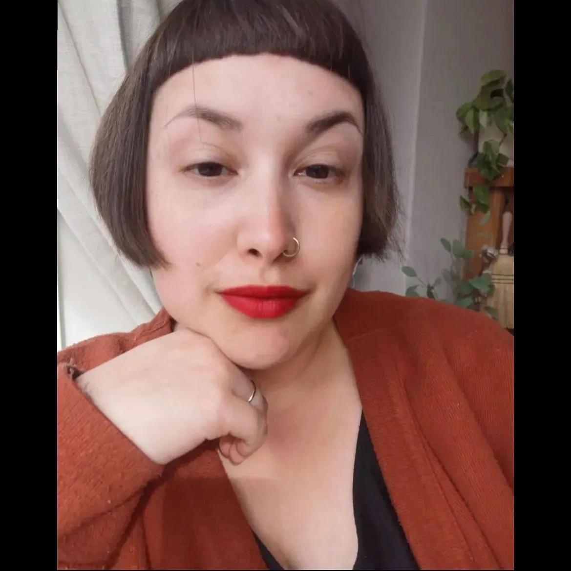 Rounded dark bob with short blunt bangs