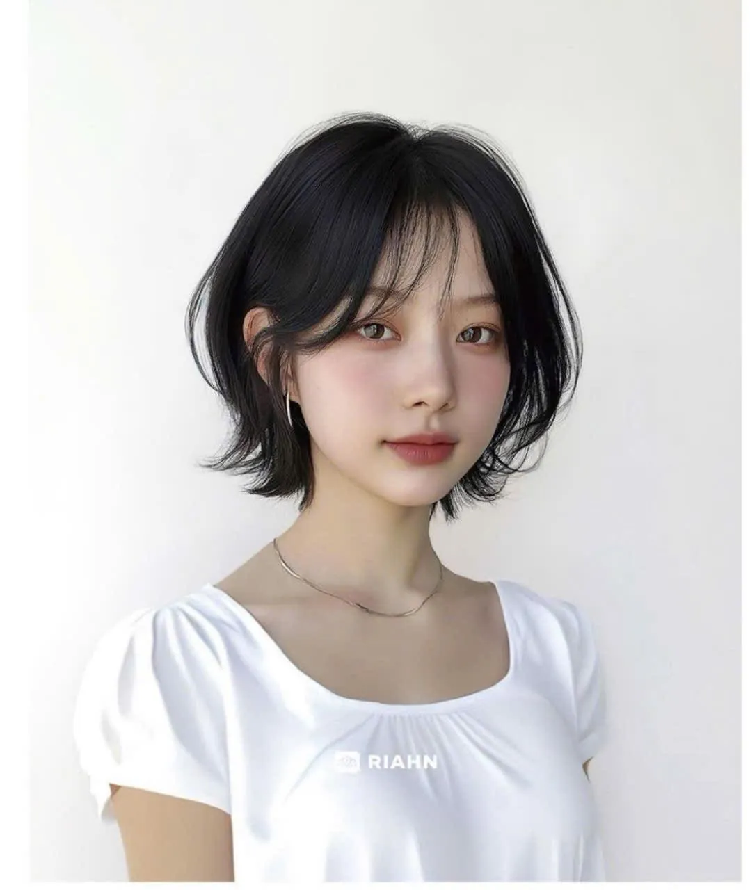 Black short bob with curtain bangs and outward ends