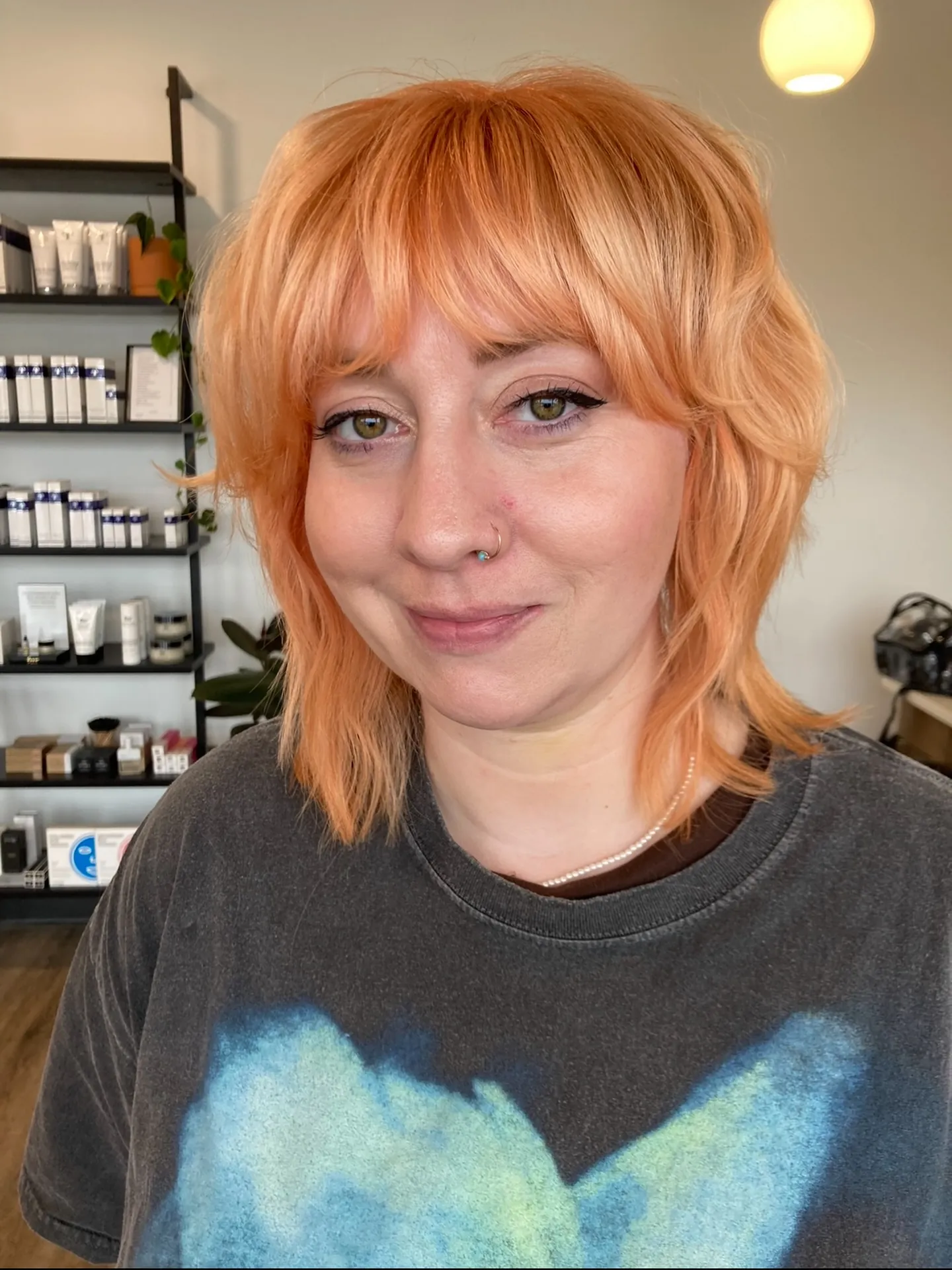 Rounded copper short shag with full bangs and soft layers
